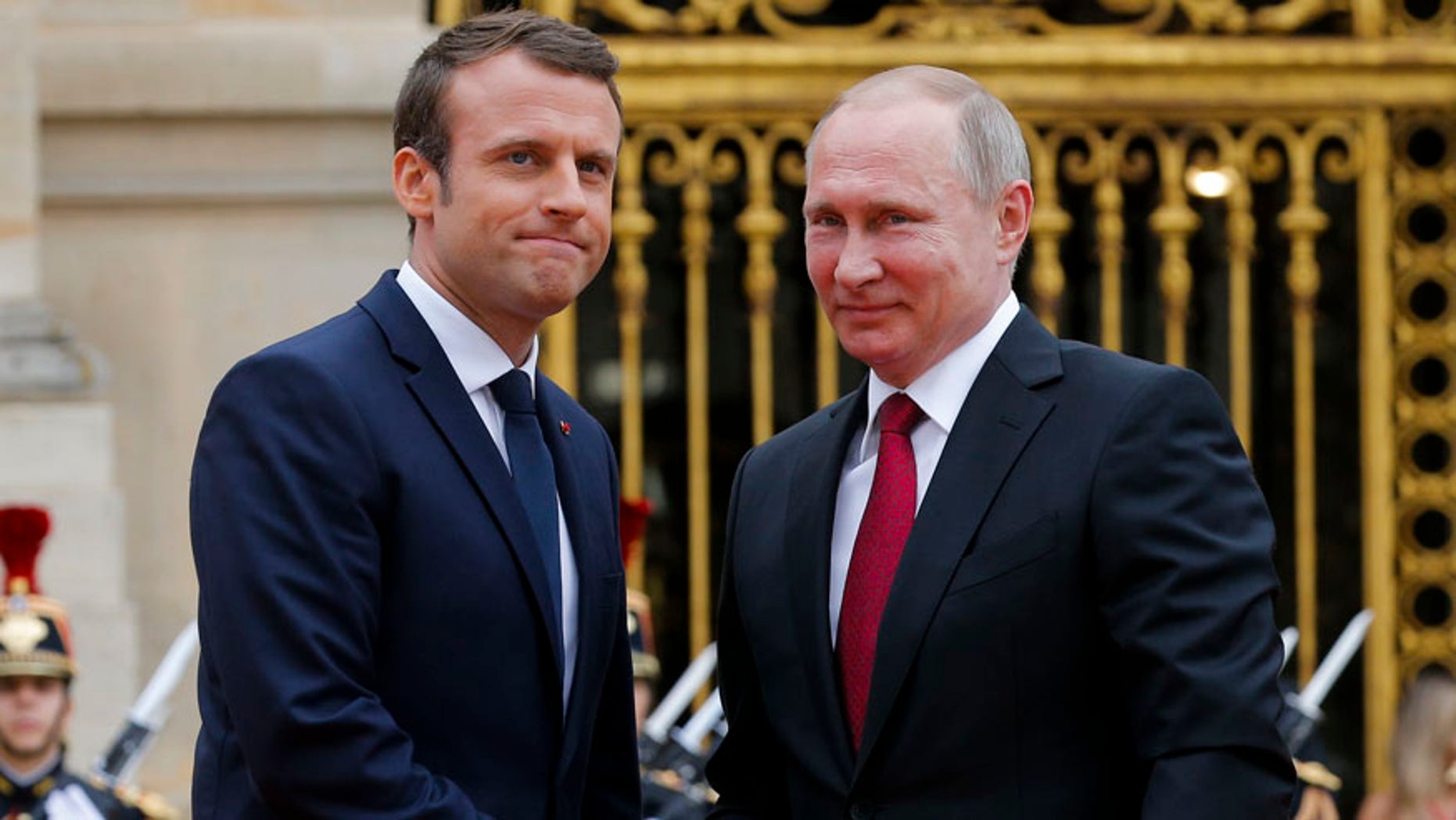May 29, 2016: Russian President Vladimir Putin, right, is welcomed by French President Emmanuel Macron at the Palace of Versailles, near Paris, France.