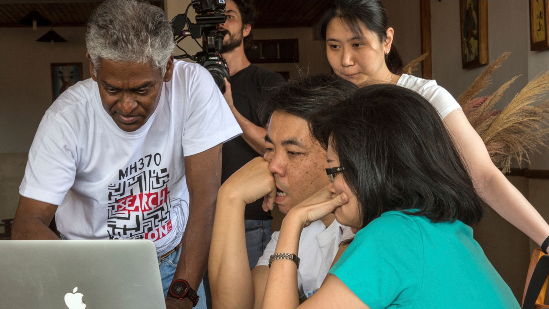 V.P.R. Nathan, left, whose wife, Anne Daisy, was on board the missing Malaysia plane, talks with other relatives of passengers during their meeting at a hotel in Antananarivo, Madagascar, Sunday, Dec.4, 2016.