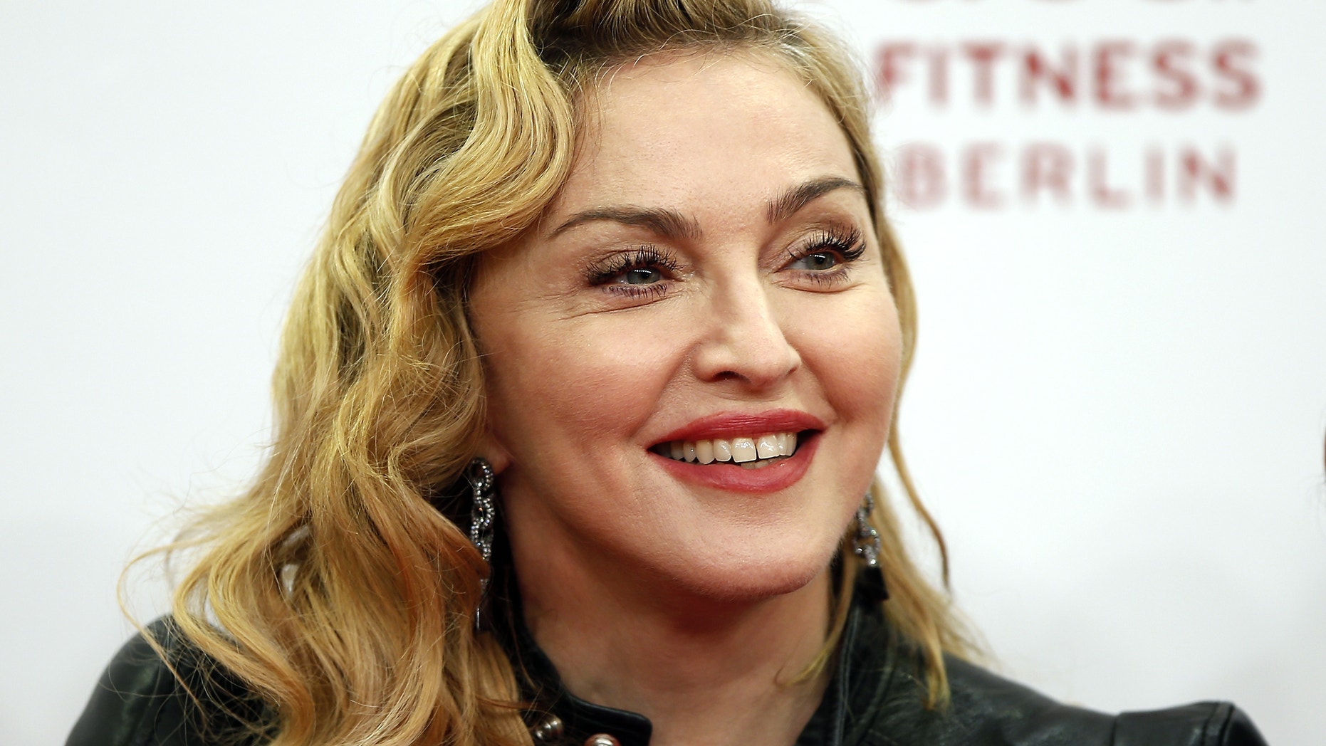 Oct. 17, 2013. Madonna smiles during her visit at the Hard Candy Fitness
center in Berlin.