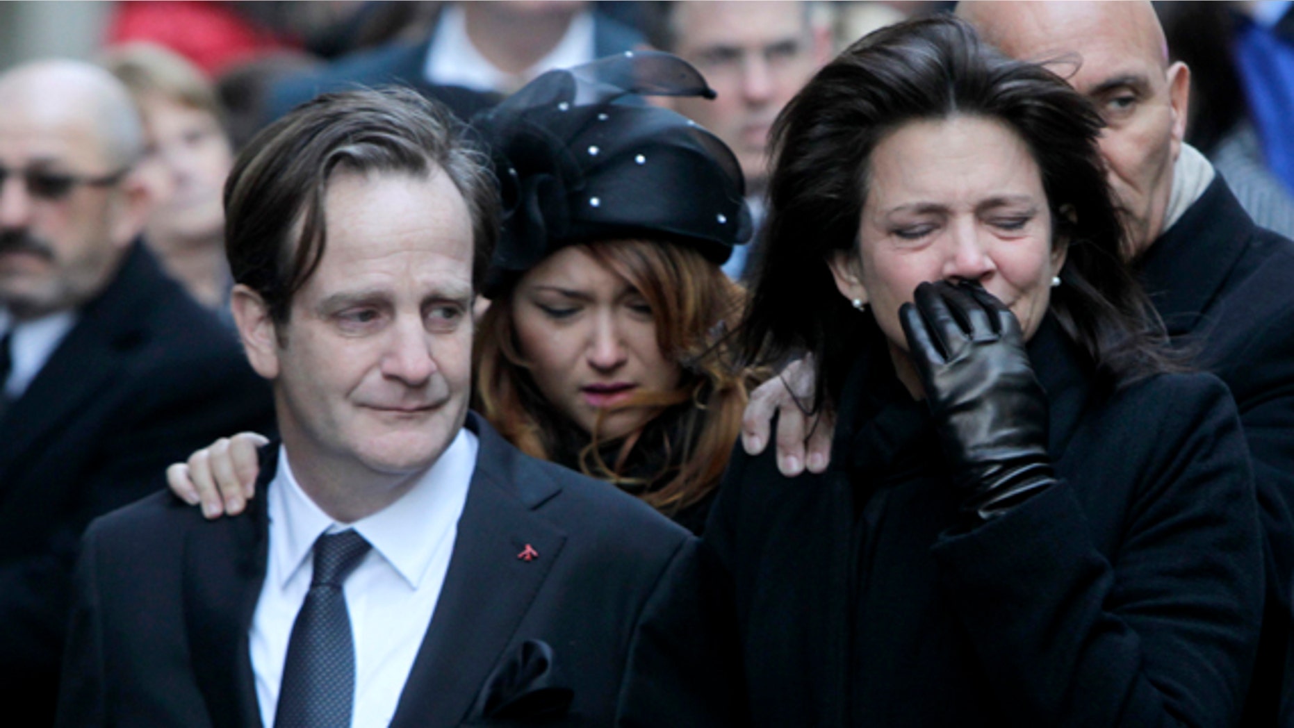 Jan. 5, 2012: Matthew Badger, left, and Madonna Badger, the parents of three children that were killed in a fire, react as their caskets are carried into a church during the funeral in New York.