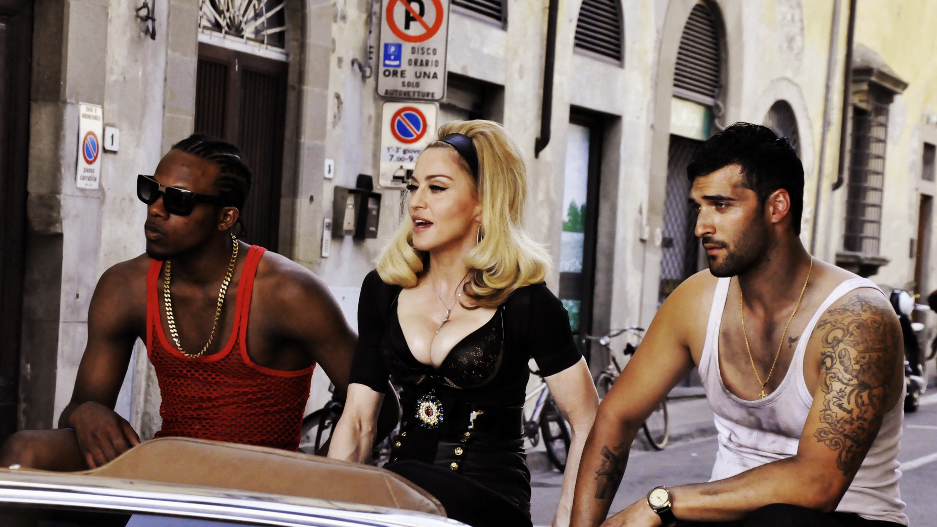 This undated image released by Guy Oseary shows pop star Madonna, center, during the filming of her music video for her new single, Turn Up The Radio, in Florence, Italy.