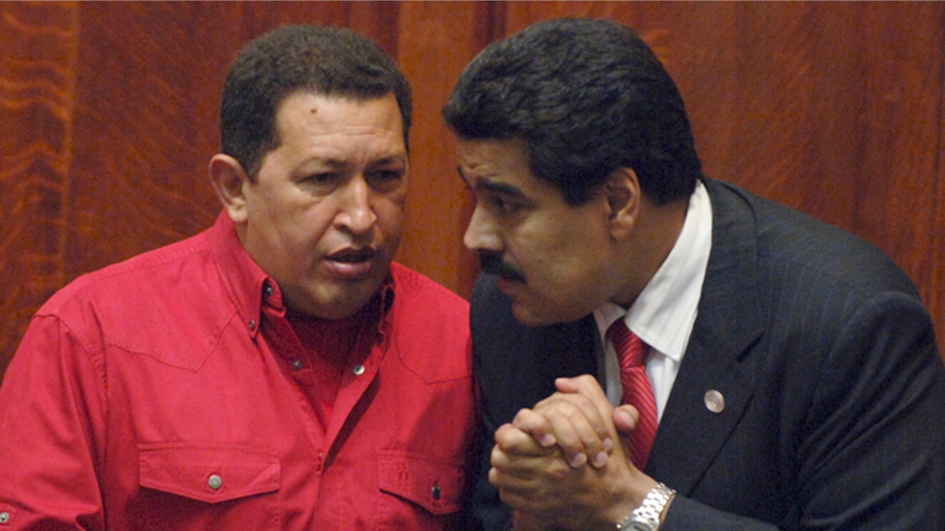 FILE: President Hugo Chavez, left, talks to then Foreign Minister Nicolas Maduro at the University of Uruguay in Montevideo, Uruguay.