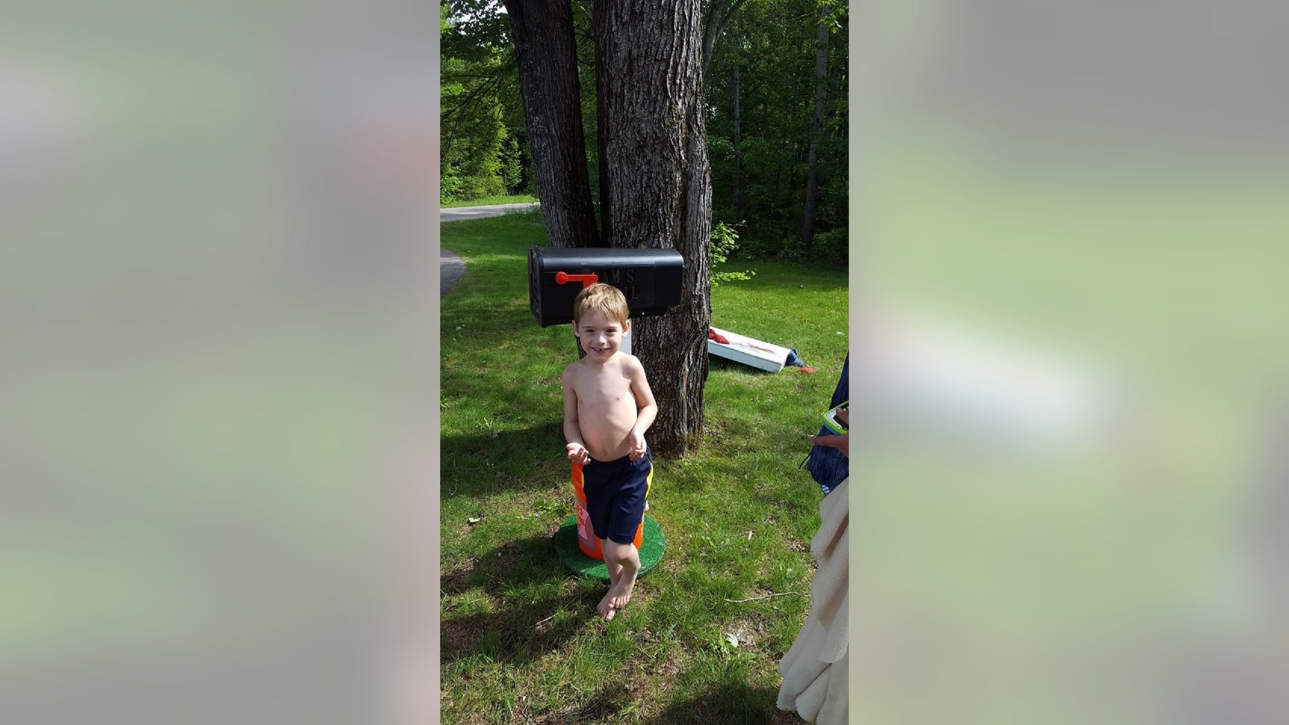 Cameron poses for a photo with his new mailbox.