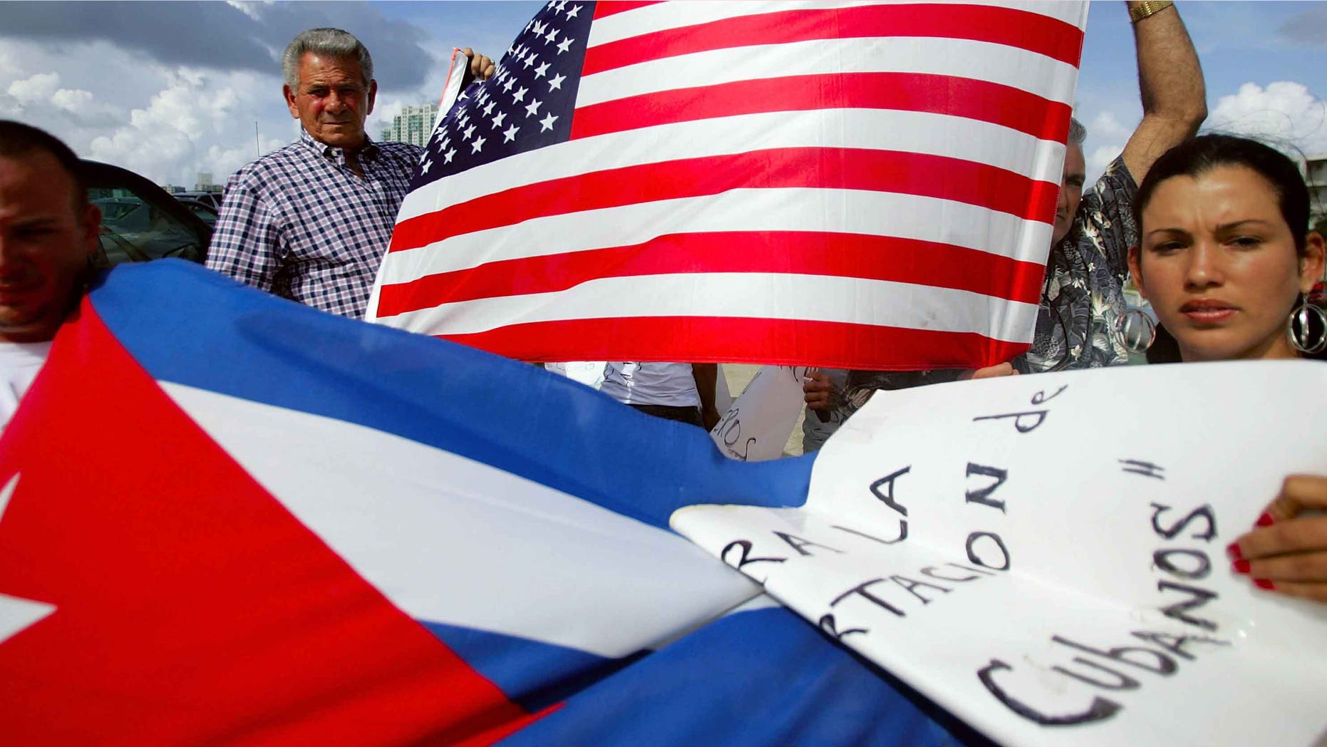MIAMI - JULY 11: Oridio Conde (L) and Laura Hernandez participate in a protest July 11, 2006 in Miami, Florida. The protest was being held by relatives and friends of the Cubans involved in this past weekend?s interdiction at sea by the U.S. Coast Guard. They want the U.S. government to allow their relatives who are being held on a Coast Guard cutter to be allowed into the United States. One person died and four others were injured when their boat ignored orders to stop by the Coast Guard. (Photo by Joe Raedle/Getty Images)