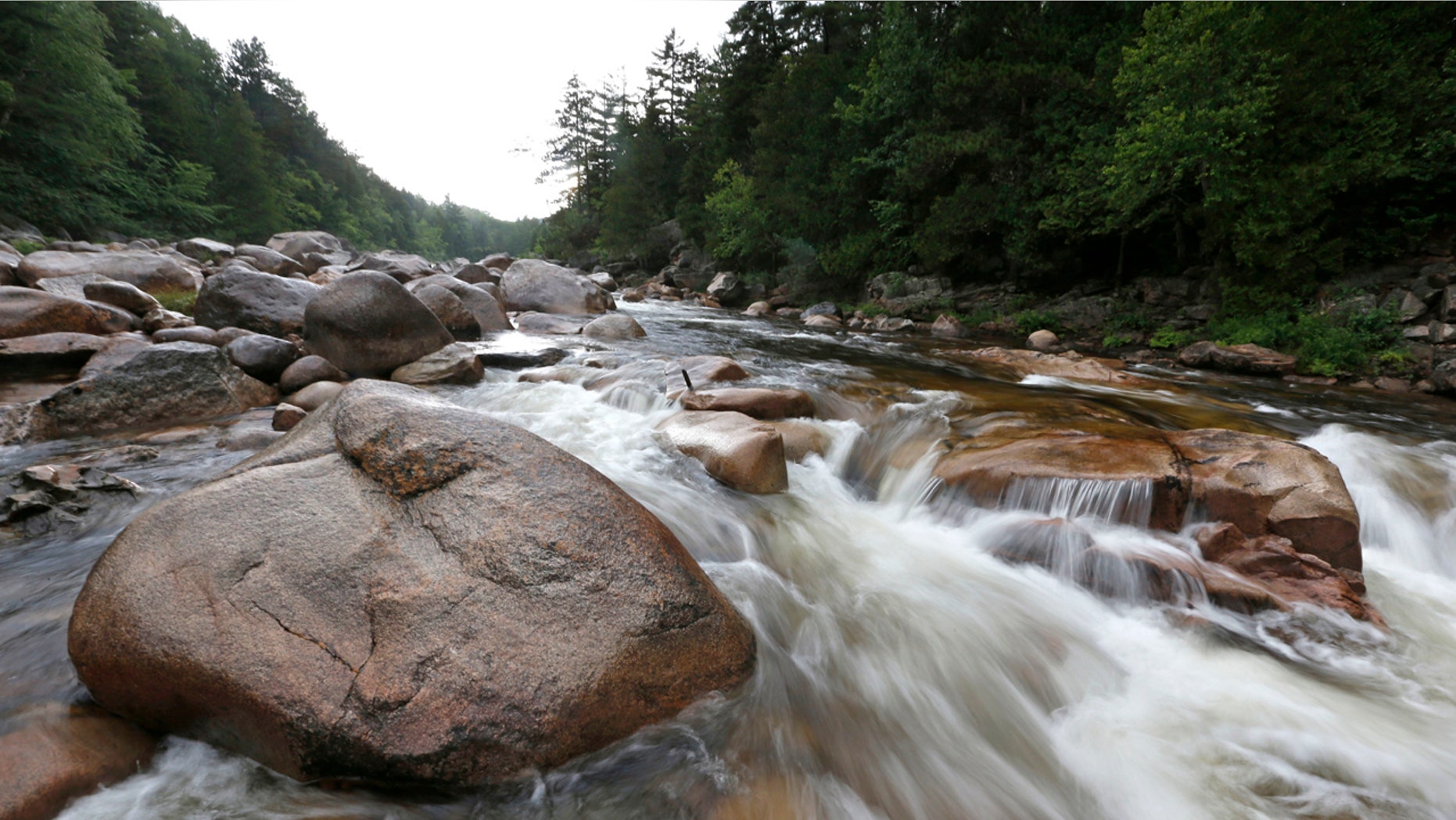In this Aug. 4, 2015, file photo, the Wassataquoik Stream flows through Township 3, Range 8, Maine, on land owned by environmentalist Roxanne Quimby, the founder of Burts Bees.