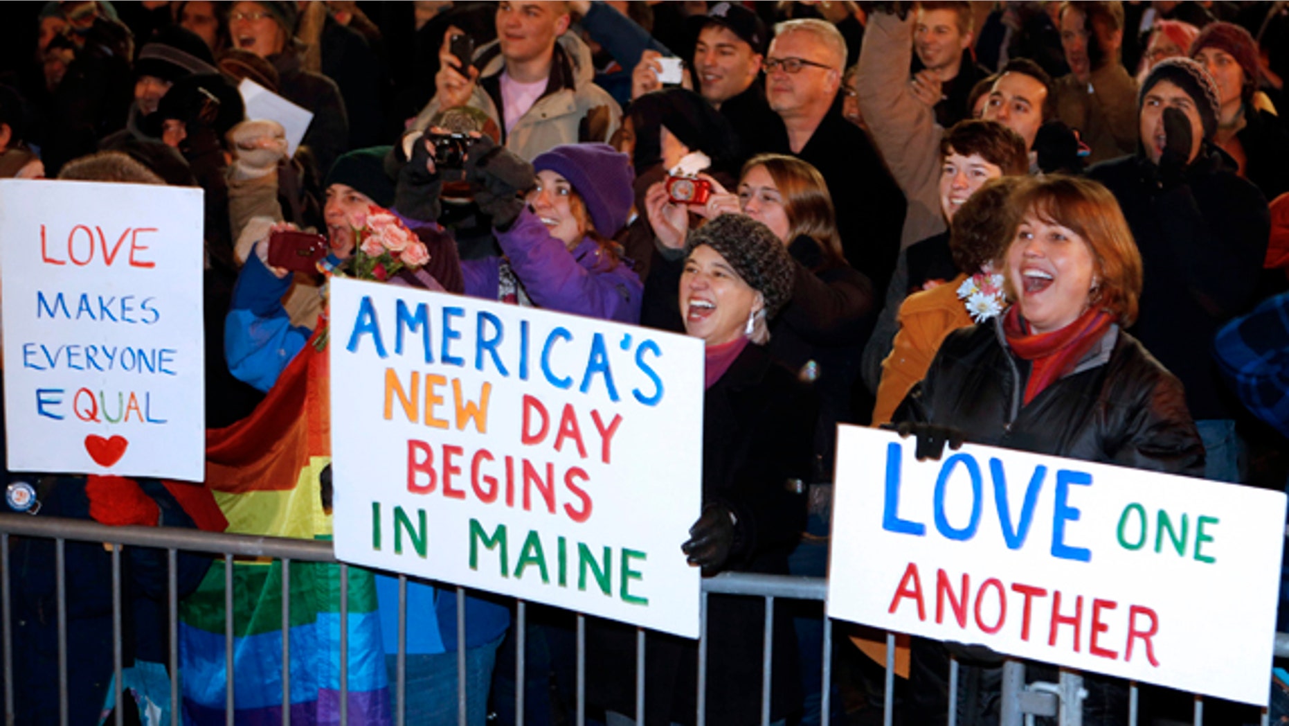 Dec. 29, 2012: A crowd cheers as the first same-sex couple to be legally married in Maine departs City Hall in Portland, Maine.