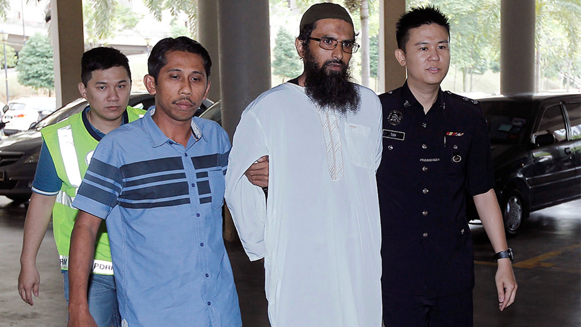 April 30, 2018: Danish national Salah Salem Saleh Sulaiman, second from right, escorted by police, arrives at a court house in Kuala Lumpur, Malaysia.