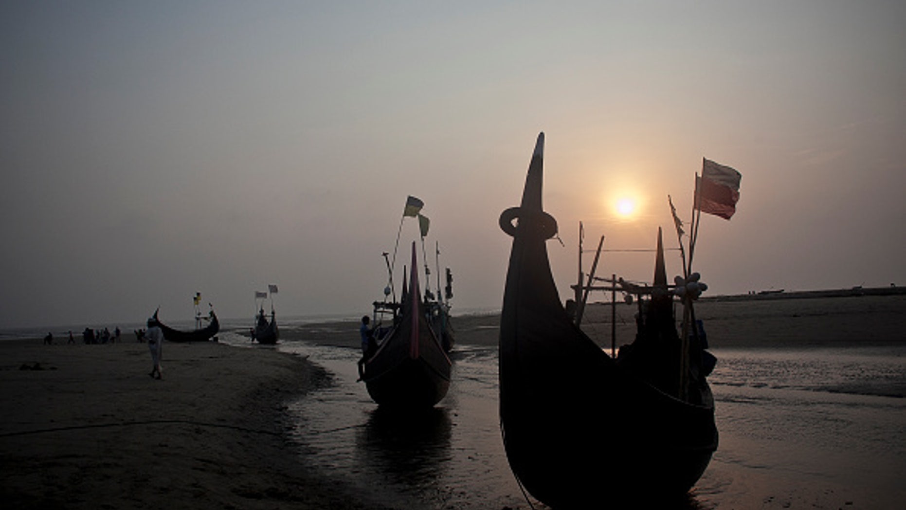 SHAMLAPUR, BANGLADESH - JULY 4: Fishing boats, like the kind that traffickers use, are seen on the beach July 4, 2015 in Shamlapur, Bangladesh. In the past months thousands of Rohingya have landed on the shores of Indonesia, Malaysia and Thailand, many of them by way of Bangladesh. The Rohingya pay up to $2,000 to traffickers, and they sail out from Bangladesh's southern coastline on fishing boats to meet larger ships in the deep sea that will take them to Malaysia. UNHCR estimates that there are more than 300,000 Rohingya living in Bangladesh. (Photo by Shazia Rahman/Getty Images)