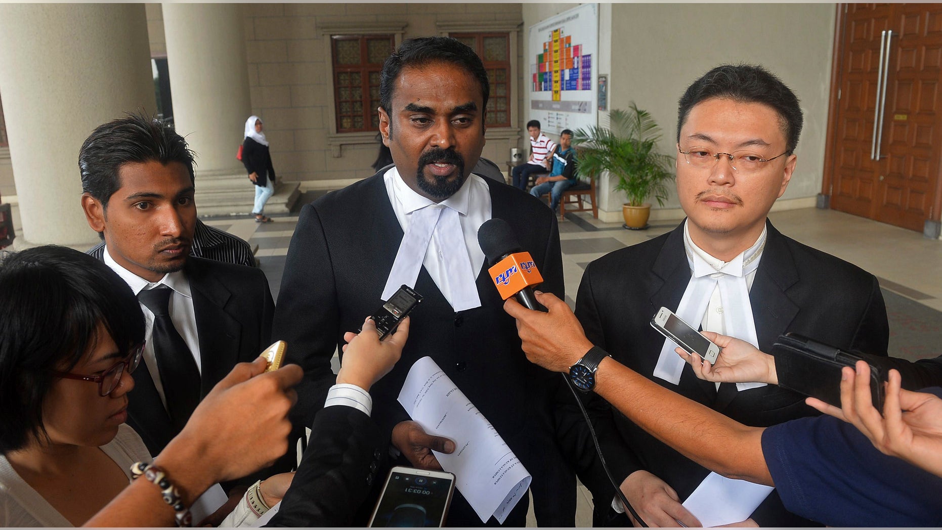 Oct. 31, 2014: Malaysian lawyer Arunan Selvaraj, center, speaks to journalists outside a courthouse in Kuala Lumpur, Malaysia.