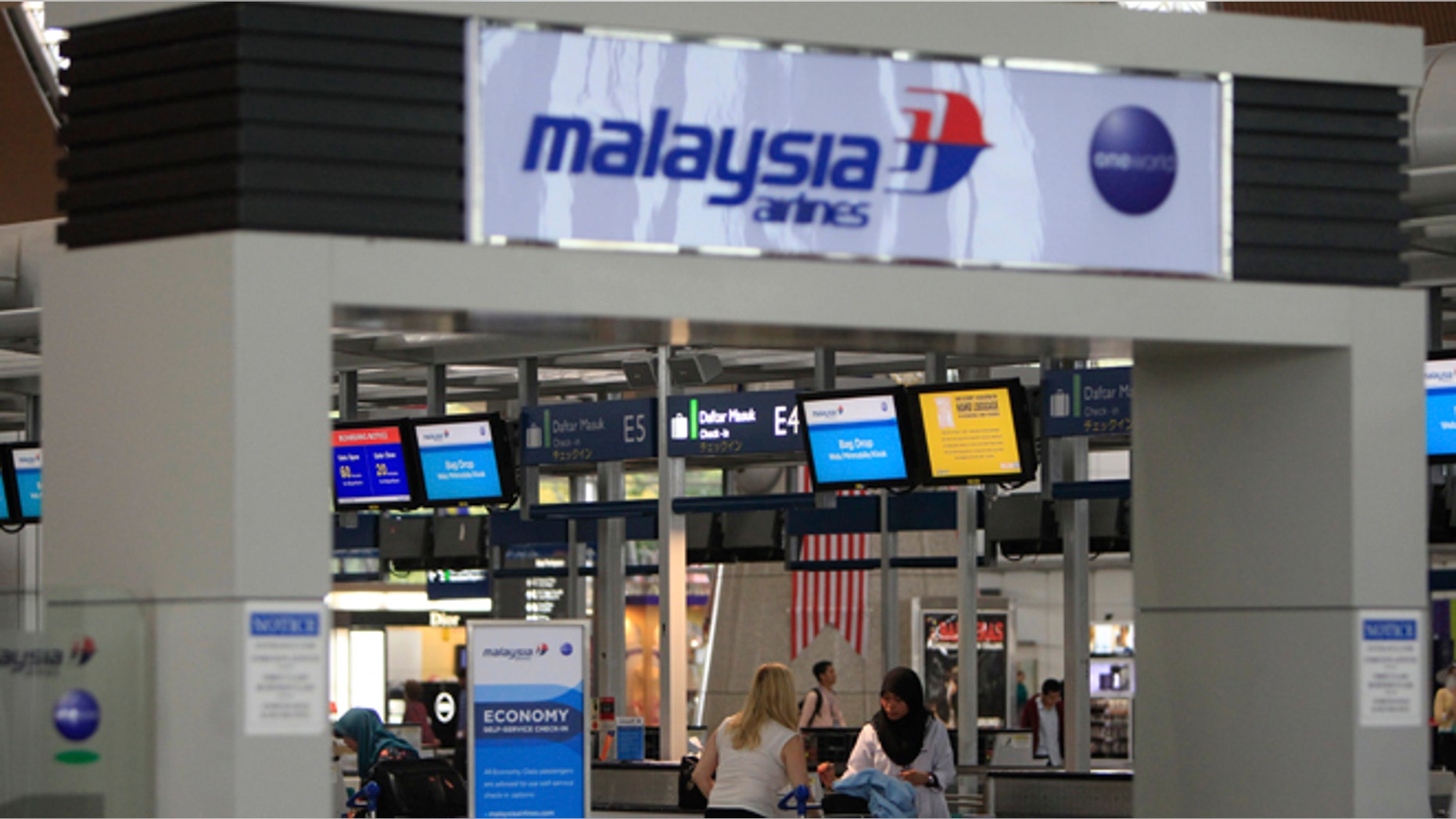Aug. 29, 2014: Passengers are ready to check in at a departure lobby at Kuala Lumpur International Airport in Sepang, Malaysia. Malaysia Airlines will cut 6,000 workers as part of an overhaul announced Friday to revive its damaged brand after being hit by double passenger jet disasters.(AP/Lai Seng Sin)