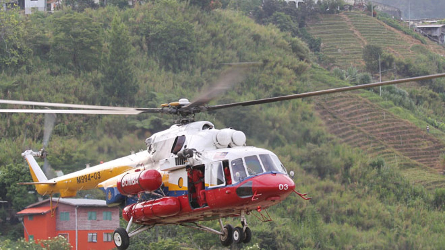 June 6, 2015:A helicopter leaves Kundasang, Malaysia for Mount Kinabalu to recover the bodies of climbers. (AP)