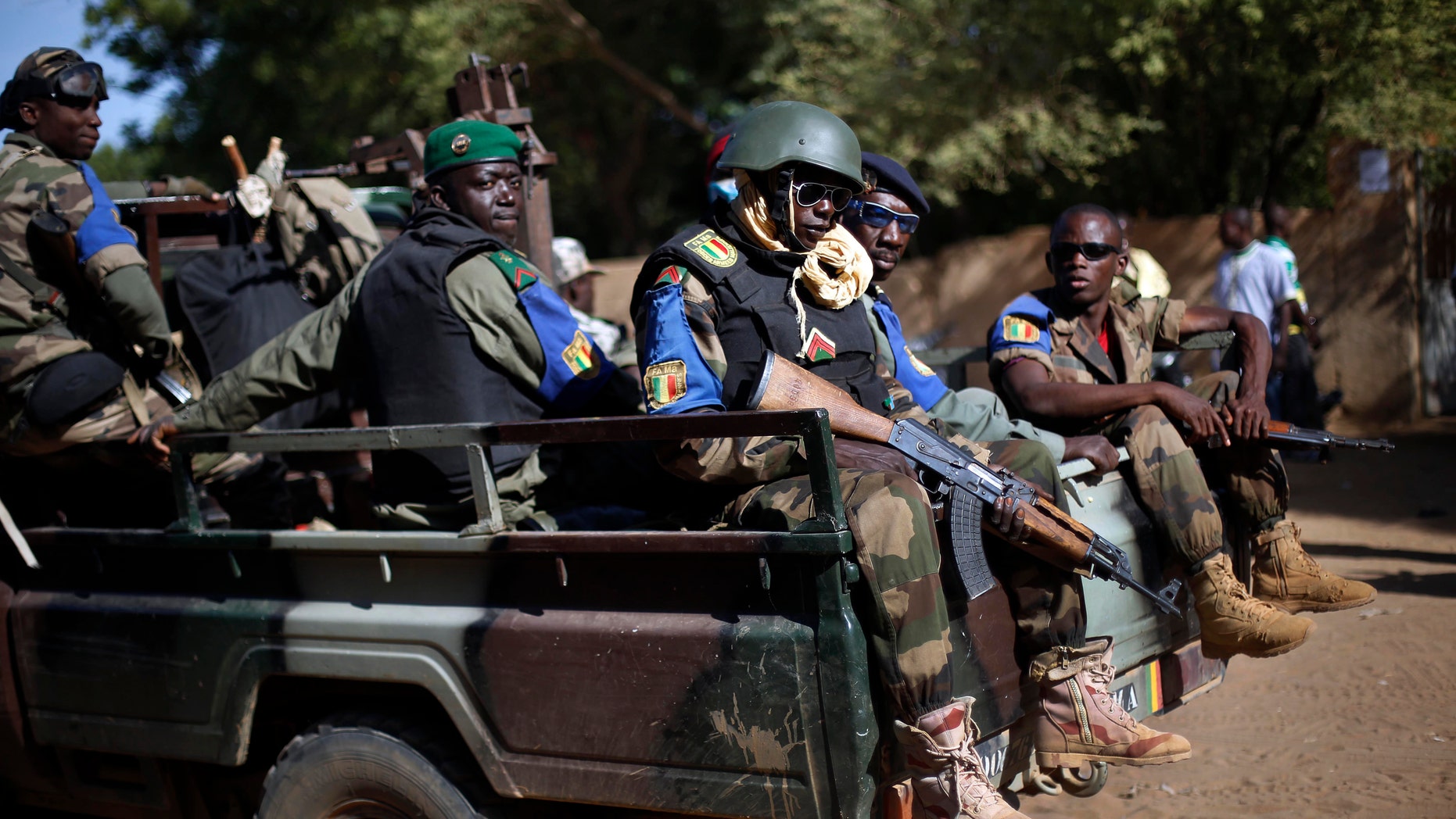 FILE - In this file photo taken on Sunday Nov. 24, 2013, the Malian army patrol the streets of Gao, Northern Mali. A doctor in northern Mali says Wednesday, Jan. 18, 2017 that at least seven people have been killed and more than 50 wounded in an attack on an installation for various armed groups, and the toll is certain to rise. (AP Photo/Jerome Delay, File)