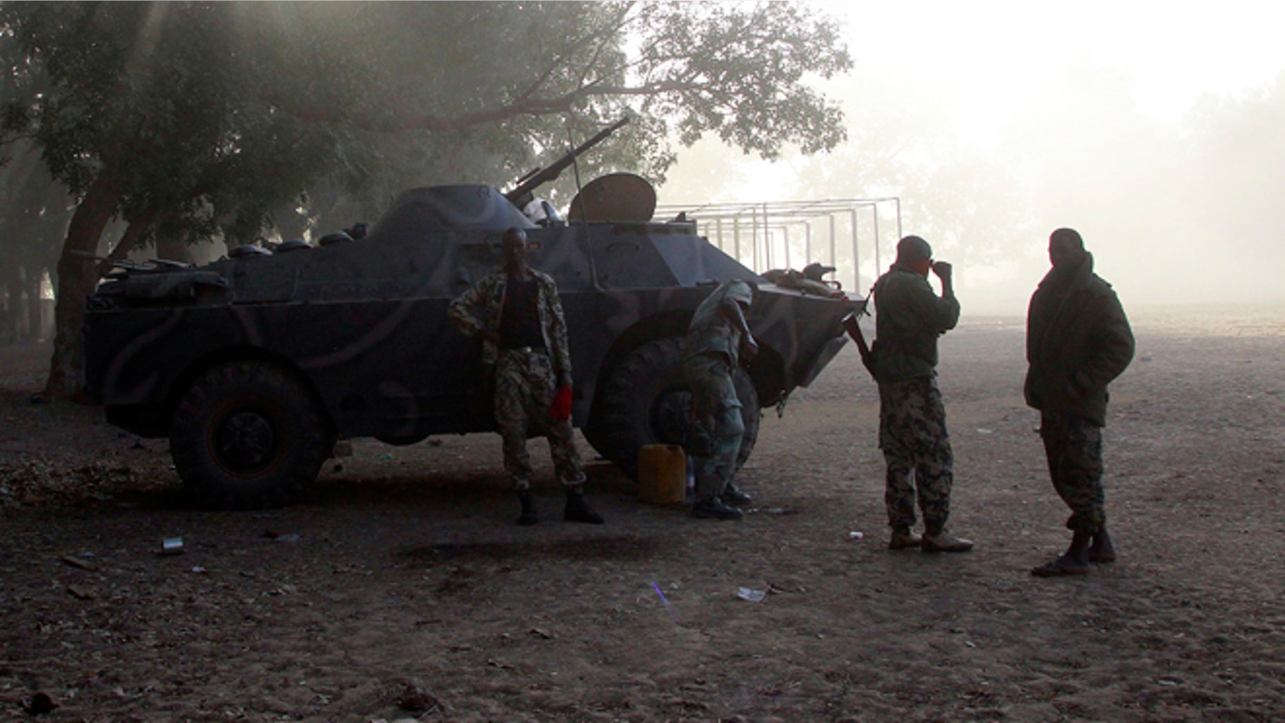 Jan. 20, 2013: Malian soldiers stand by their APC as a French Puma transport helicopter lands to test the field in the center of Niono, some 400 kms (300 miles) North of the capital Bamako.