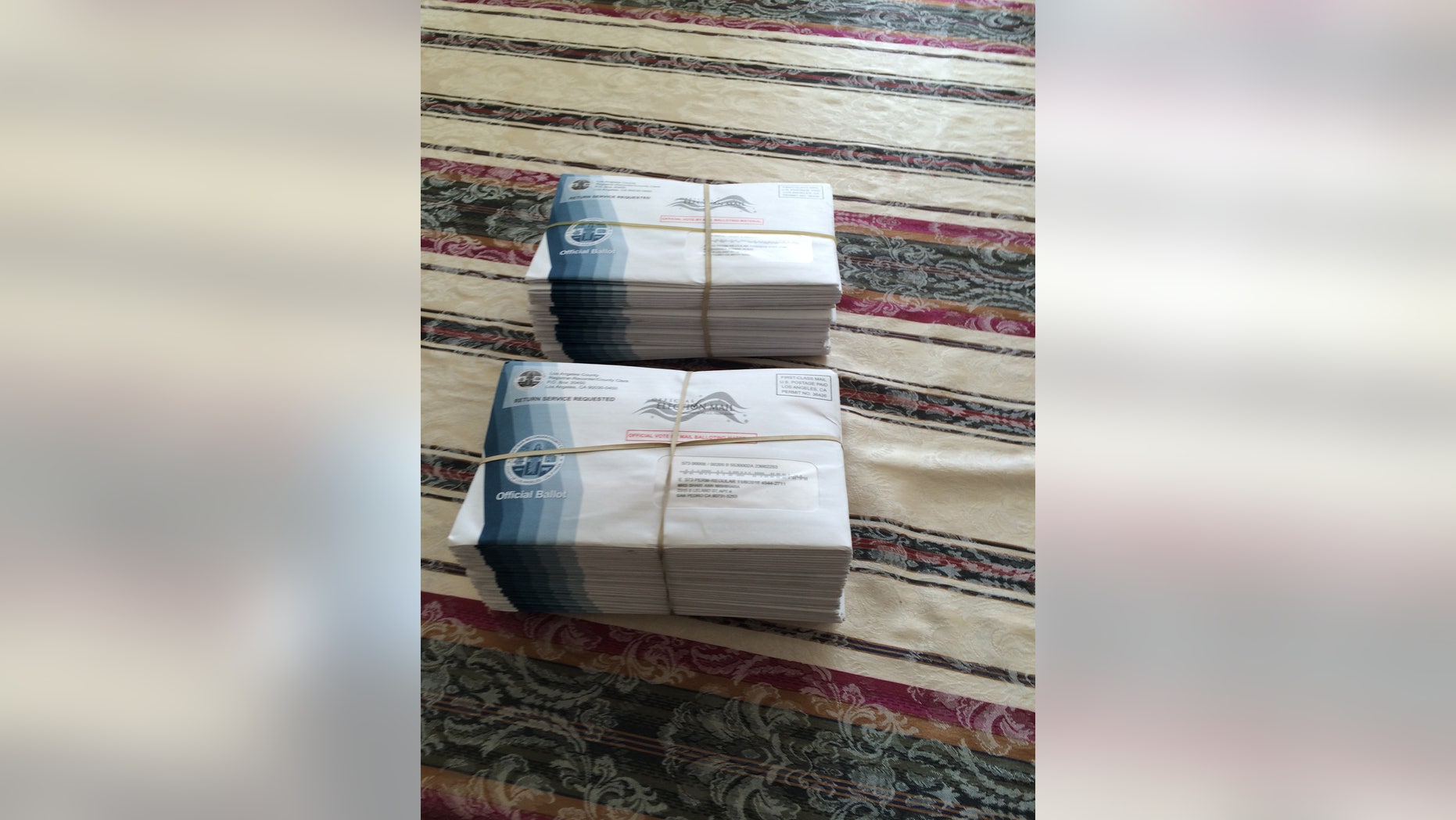 Two stacks of ballots that were found outside Jerry Mosna's home in San Pedro, Calif.