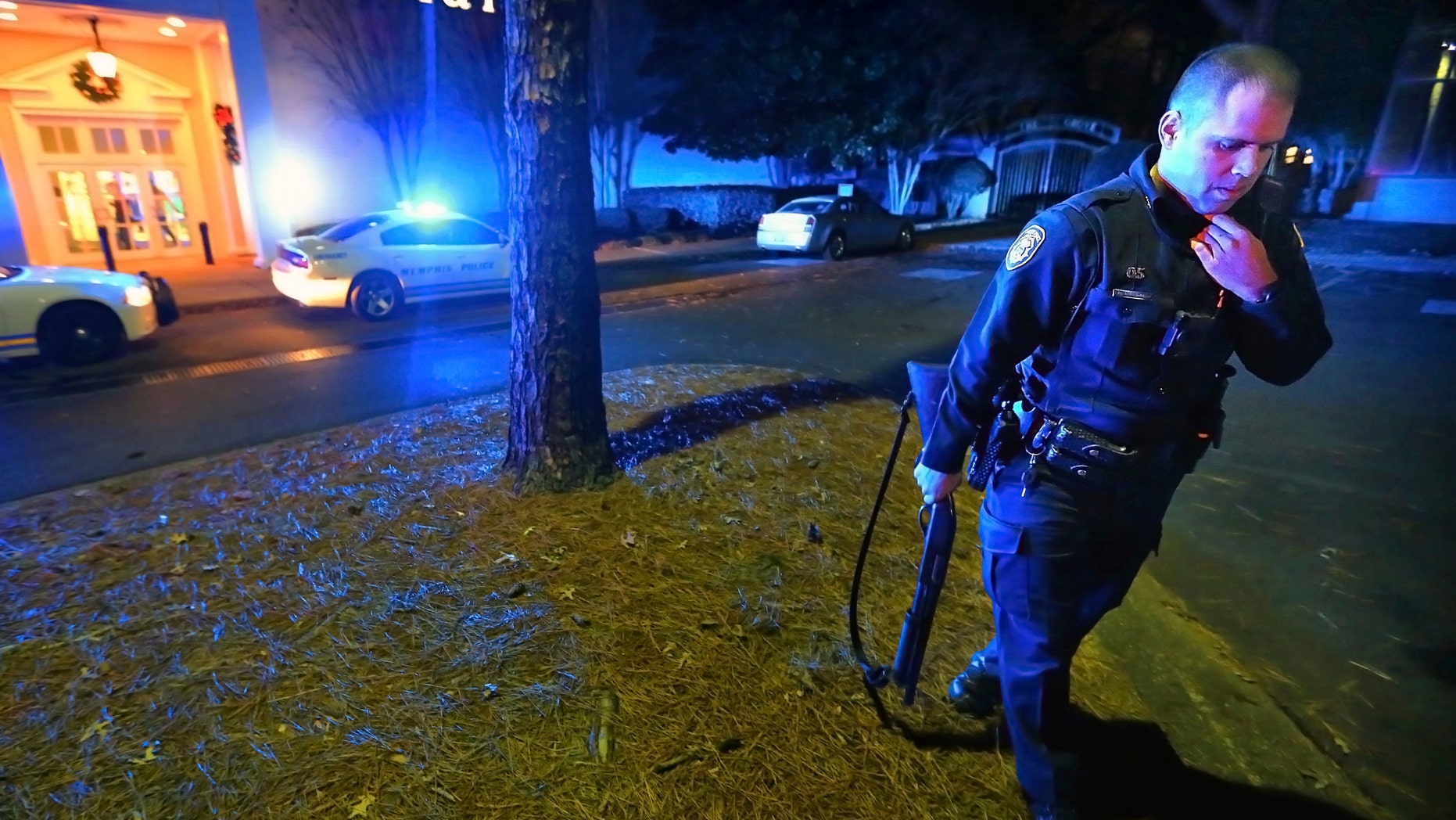 Memphis police officers block off the entrances to the Oak Court Mall on Monday, Dec. 26, 2016, after a disturbance at the mall in Memphis, Tenn. Authorities and witnesses say there have been disturbances at two malls in Memphis and one of them had to be shut down. (Jim Weber/The Commercial Appeal via AP)