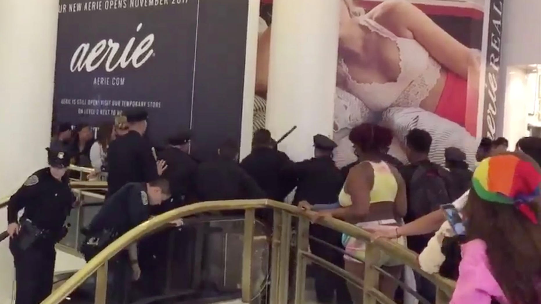 Video taken at the Westfield Mall in San Francisco shows officers trying to break up large fight Sunday night. (@GeorgeTheCat, Twitter)