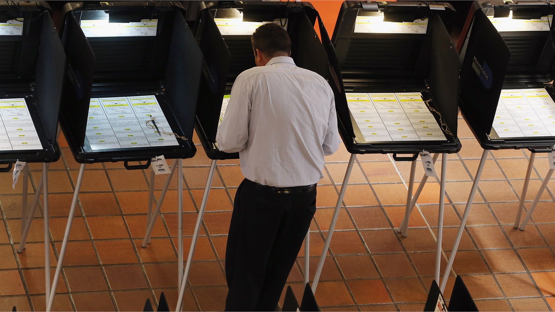 MIAMI, FL - APRIL 29: A voter fills out a ballot during the early voting period on a ballot issue to decide if the Miami Dolphins and their owner Stephen Ross will be able to tap into $289 million in public funding that the team is seeking to help renovate their stadium on April 29, 2013 in Miami, Florida. Early voting started without a clear understanding if it will even be counted because the stadium renovation plan is dependent on the Florida legislature voting to increase the Miami-Dade mainland hotel tax rate from 6 to 7 percent and they have not yet decided to vote on that issue themselves. (Photo by Joe Raedle/Getty Images)