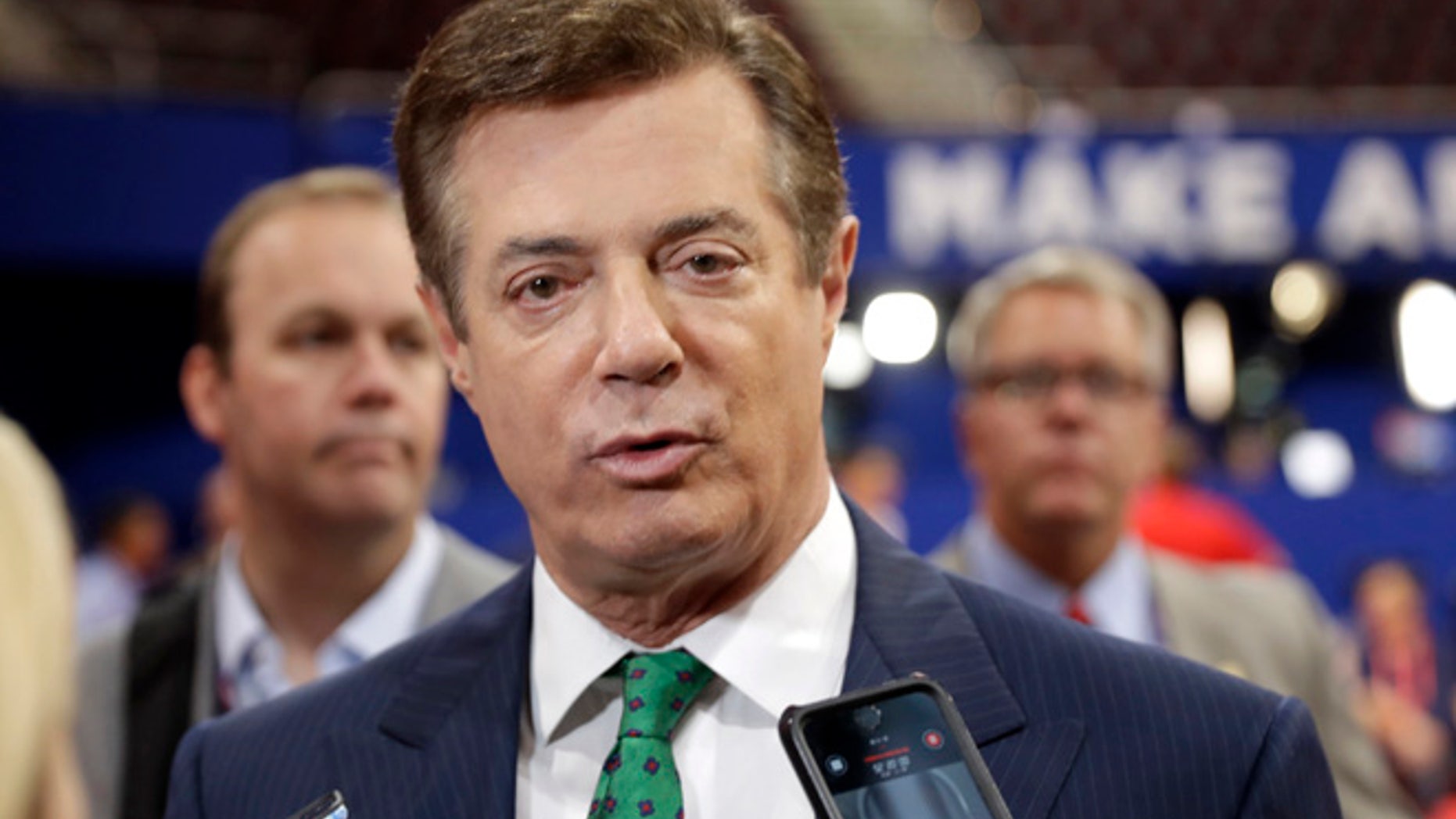 FILE - In this July 17, 2016 file photo, Trump Campaign Chairman Paul Manafort talks to reporters on the floor of the Republican National Convention at Quicken Loans Arena, Sunday, in Cleveland. (AP Photo/Matt Rourke, File)