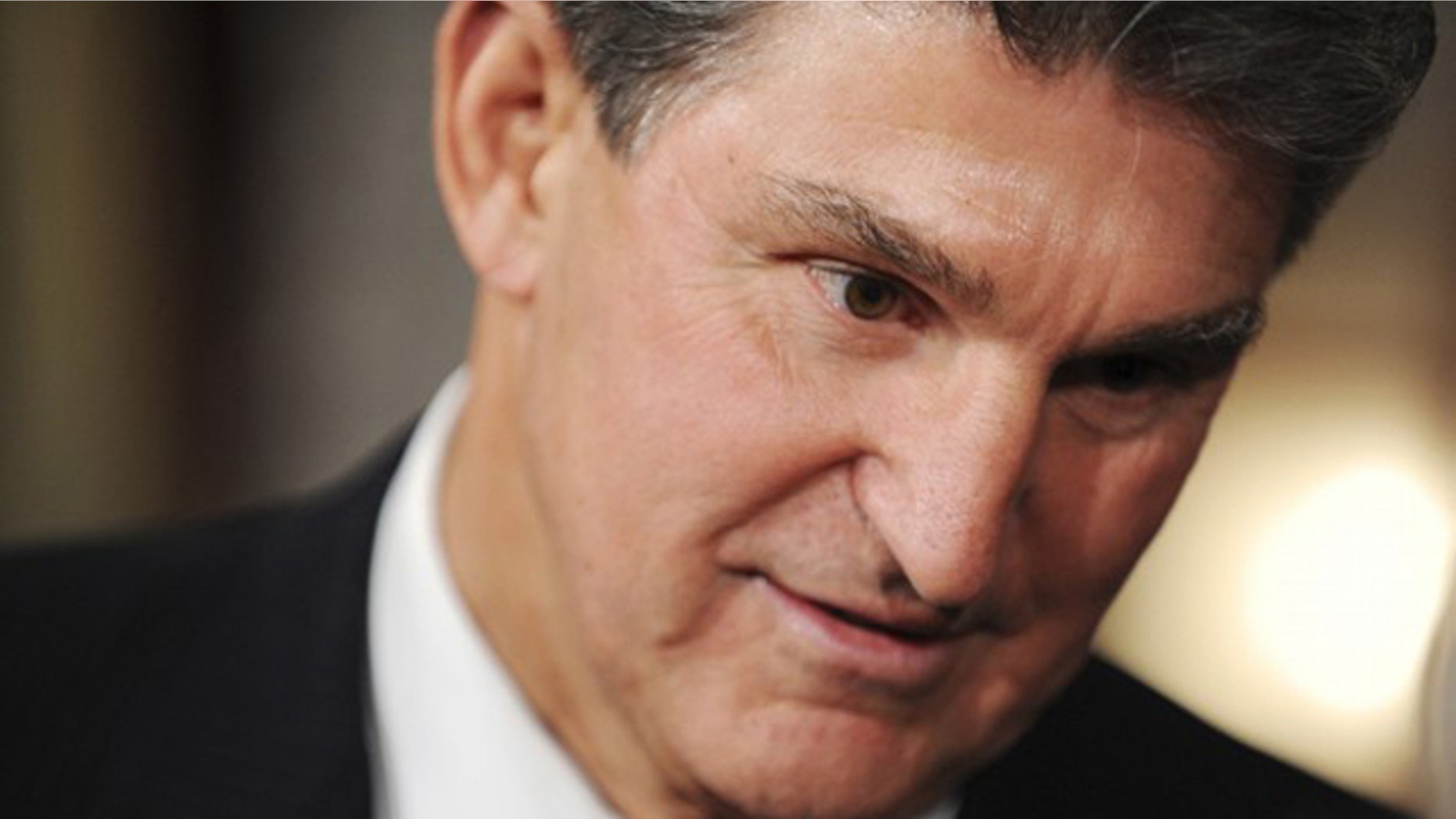 In this Nov. 15, 2010 photo, Sen. Joe Manchin talks with family members after being ceremonially sworn in at the U.S. Capitol in Washington.