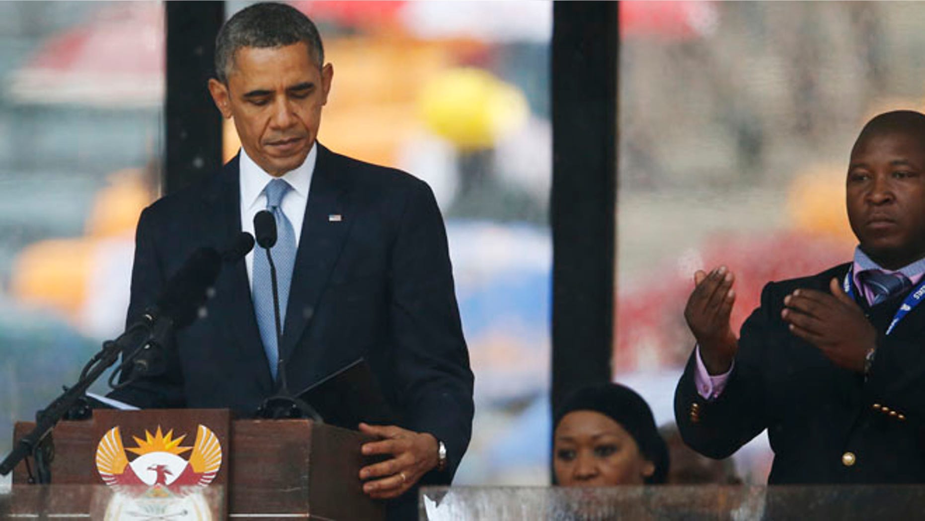 Dec. 10, 2013: President Barack Obama looks down as he stands next to the sign language interpreter as he makes his speech at the memorial service for former South African president Nelson Mandela at the FNB Stadium in Soweto near Johannesburg. South Africa's deaf federation said on Wednesday that the interpreter on stage for Mandela memorial was a "fake." (AP)