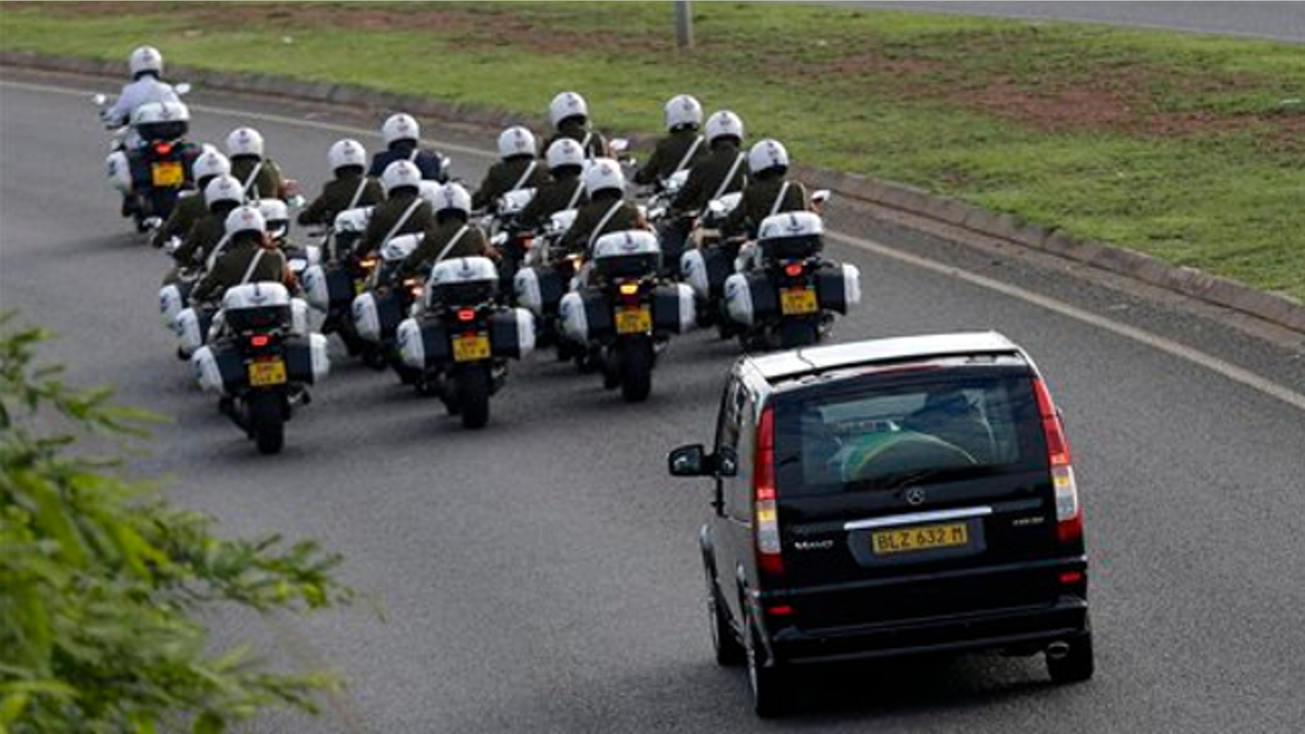 Dec. 14, 2013: Motorcycles escort a hearse carrying the casket of former South African President Nelson Mandela en route to Waterkloof Air Base on the outskirts of Pretoria, South Africa.