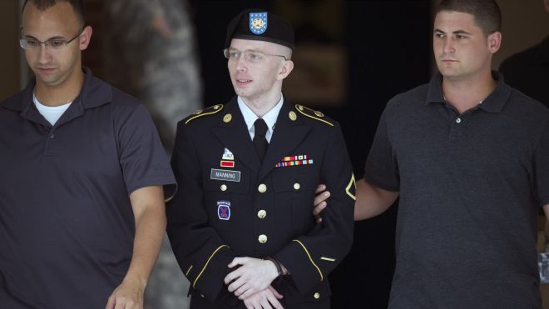 July 25, 2013: Army Pfc. Bradley Manning is escorted out of a courthouse at Fort Mead, Md.