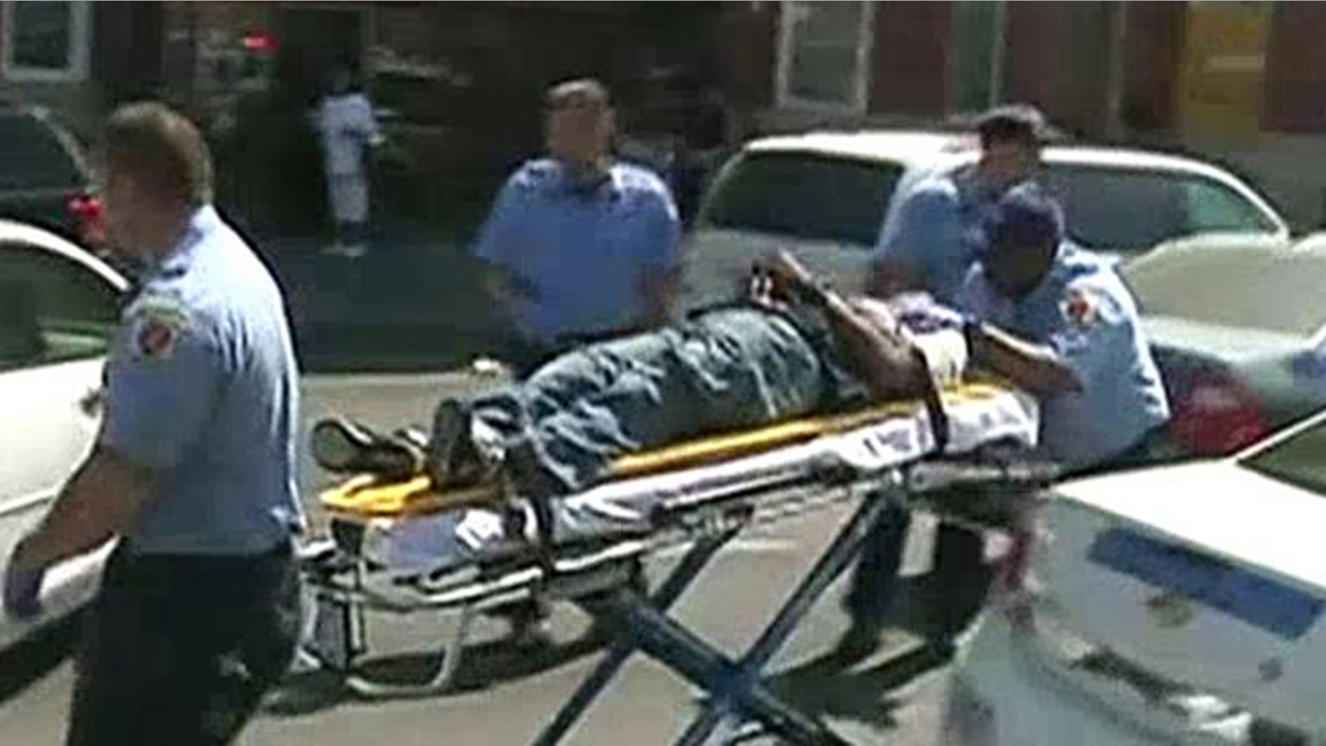 The unidentified man is seen in a stretcher after gunfire was heard Monday in Baltimore, Md.