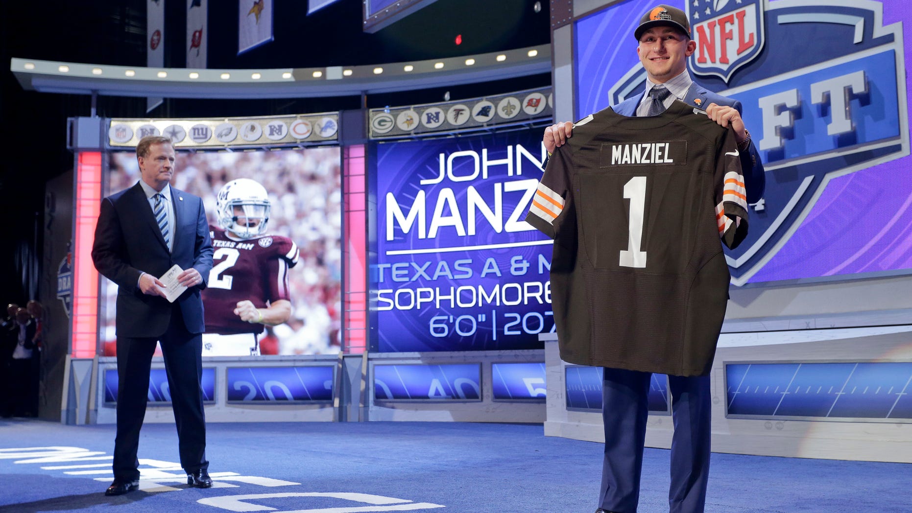 May 8, 2014. Texas A&M quarterback Johnny Manziel poses for photos after being selected by the Cleveland Browns as the 22nd pick in the first round of the 2014 NFL Draft in New York.