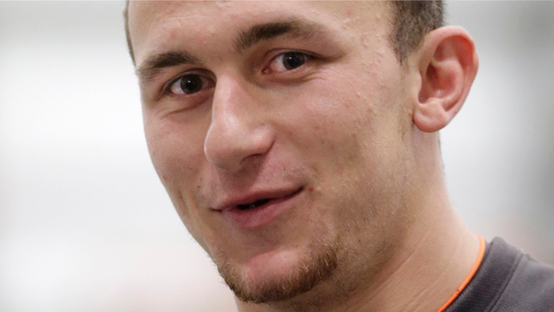 In this pool photo provided by the Cleveland Browns, quarterback Johnny Manziel talks with reporters after a workout at NFL football rookie minicamp at the team's facility in Berea, Ohio in this May 17, 2014 file photo.