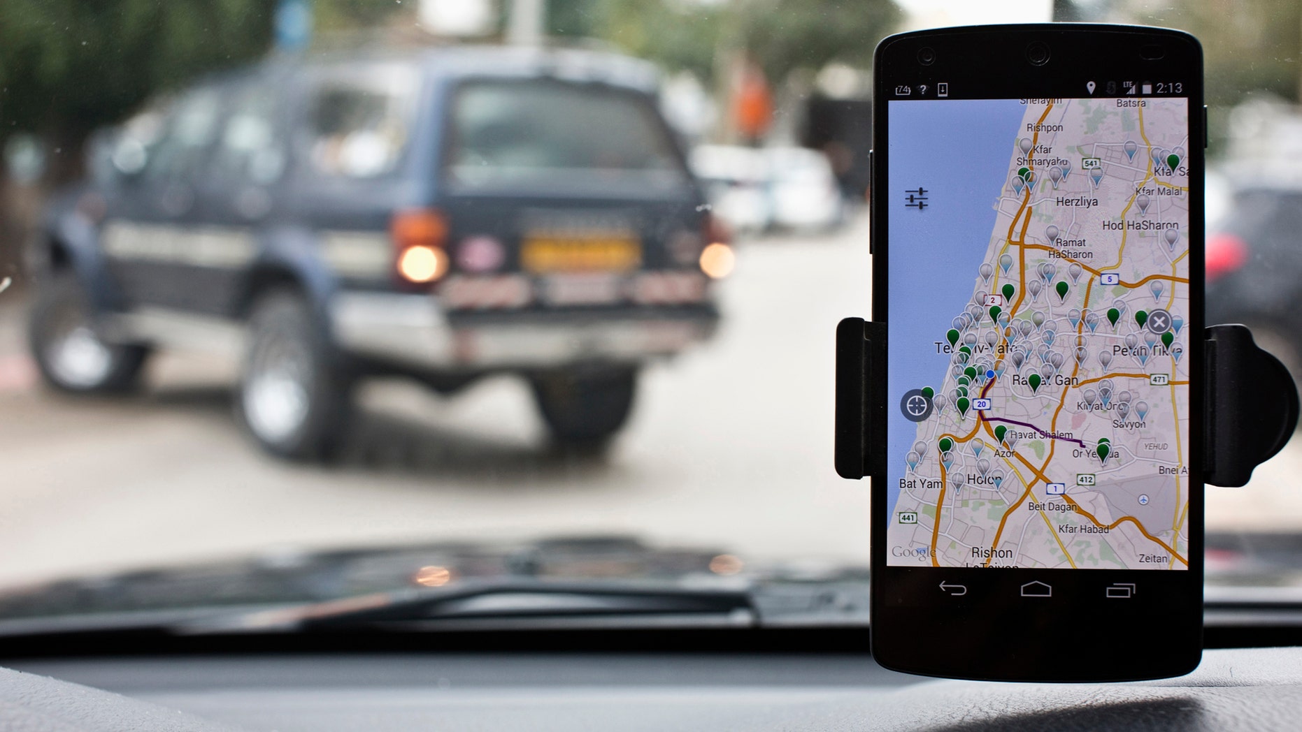 File photo: Anagog, an Israeli parking app, is seen on a smartphone in this photo illustration taken in Tel Aviv February 18, 2015. (REUTERS/Nir Elias)