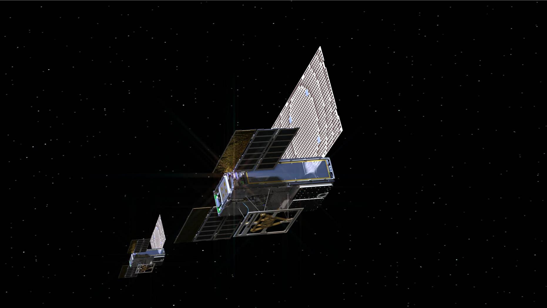 An artist's depiction of the tiny twin MarCO spacecraft on their way to Mars.
