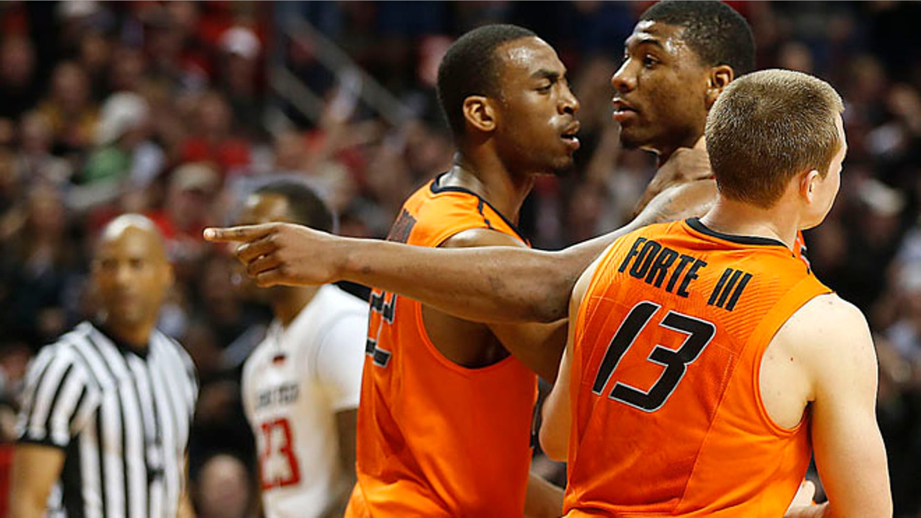 Feb. 8, 2014: Oklahoma State's Markel Brown (22) and Phil Forte (13) hold Marcus Smart (33) after Smart shoved a fan during their NCAA college basketball game in Lubbock, Texas.