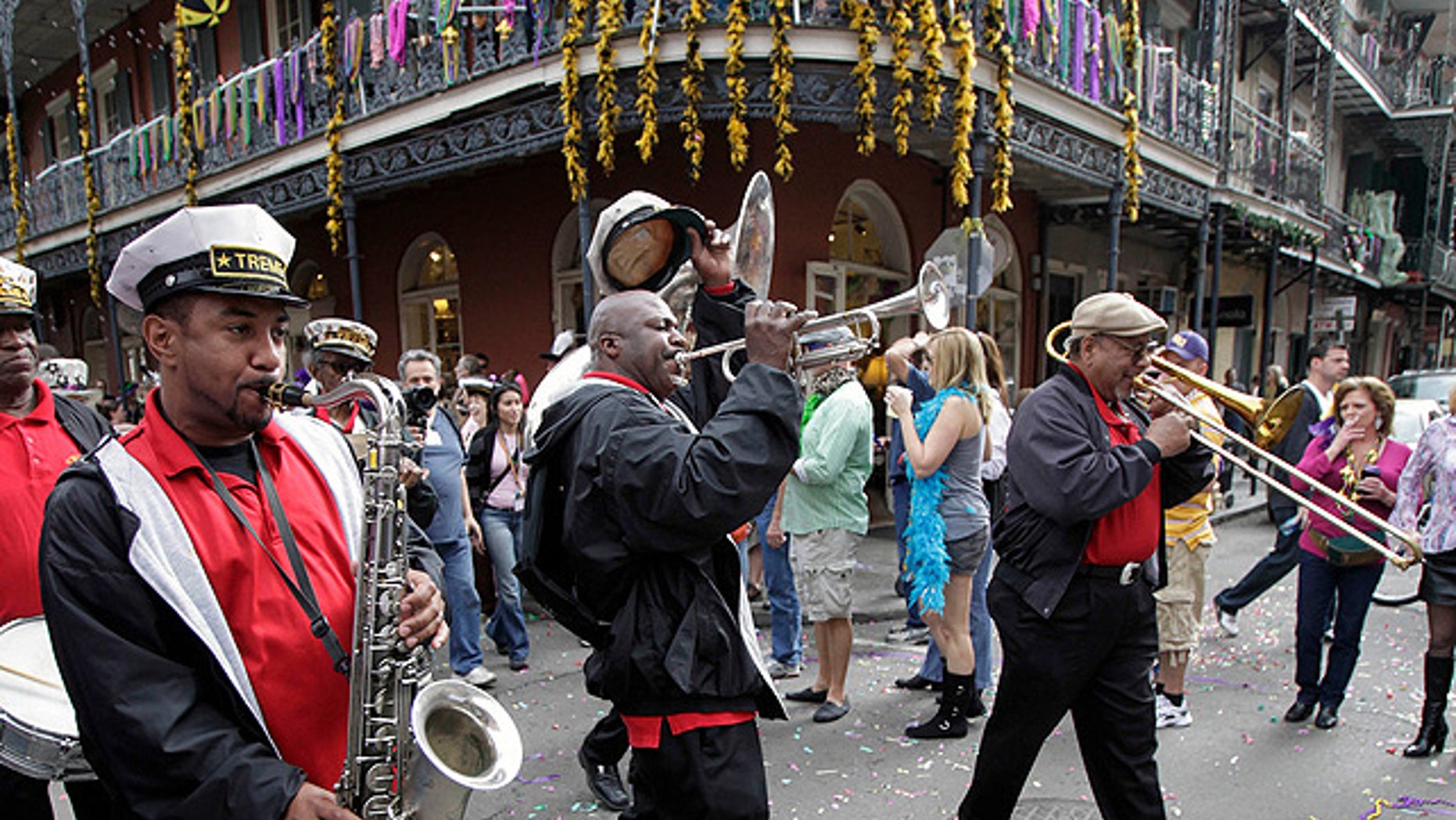 Feb. 21, 2012: Revelers celebrate Mardi Gras in New Orleans' French Quarter, a popular spot for tour guides who say newly-enforced city regulations are trampling their First Amendment rights. (AP)