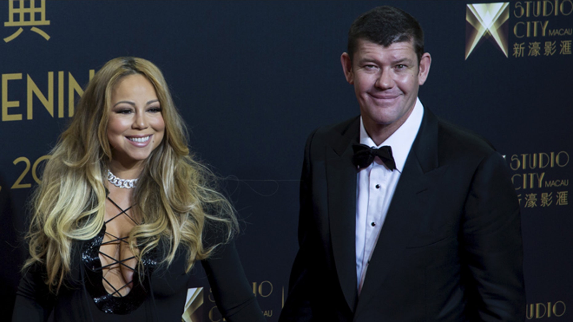 October 27, 2015. Singer Mariah Carey (L) and Australian billionaire James Packer, co-chairman of Melco Crown Entertainment, pose on the red carpet before the opening ceremony of Studio City in Macau, China.