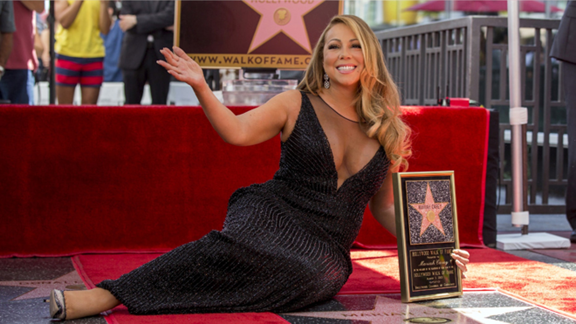 August 5, 2015. Mariah Carey poses with her star after it was unveiled on the Hollywood Walk of Fame in Los Angeles.