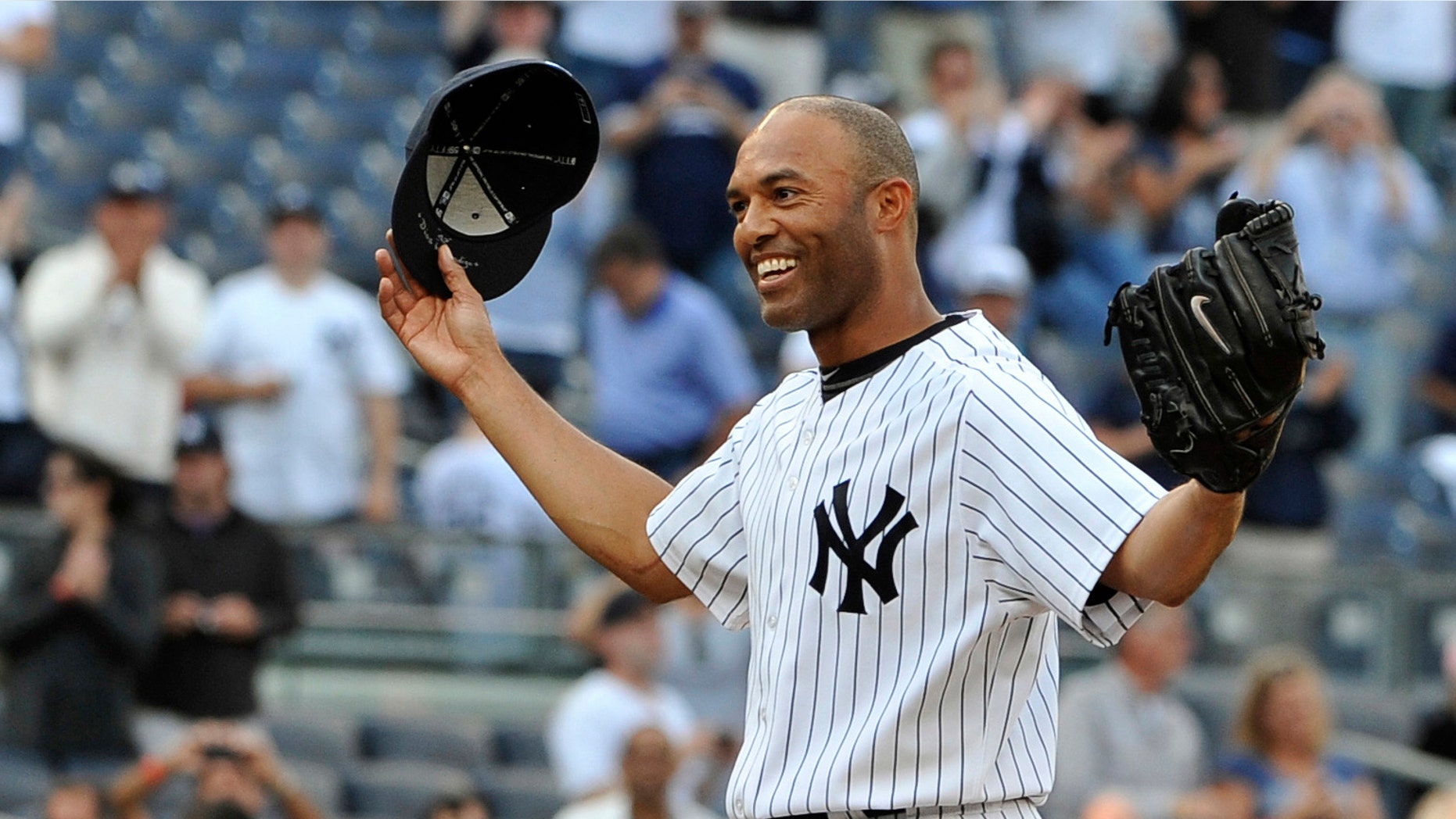 New York Yankees closer Mariano Rivera acknowledges the cheers of the crowd after recording his 602nd career save, after the Yankees beat the Minnesota Twins 6-4 at Yankee Stadium in New York, on Sept, 19, 2011.