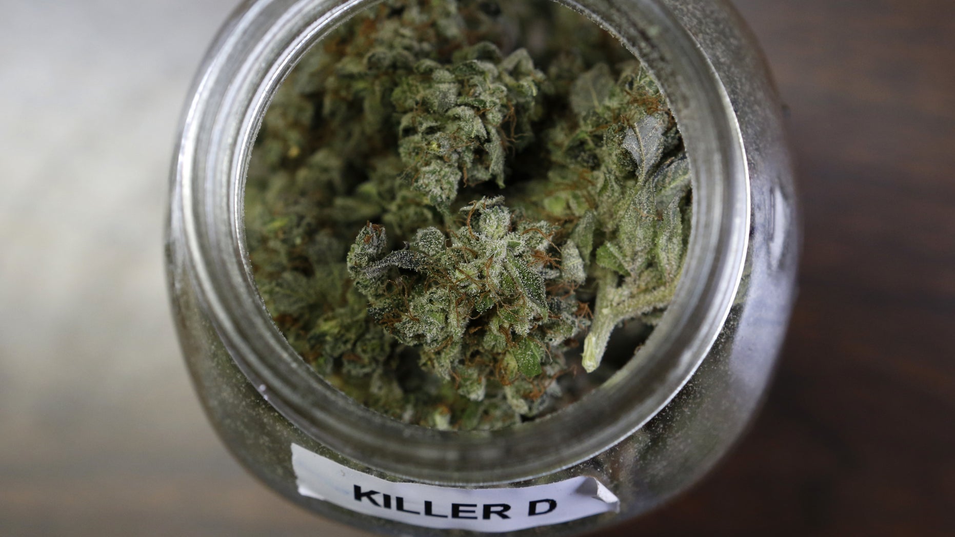 In this Friday, April 22, 2016 photo, a jar containing a strain of marijuana nicknamed "Killer D" is seen at a medical marijuana facility in Unity, Maine. A growing number of health experts and law enforcement officials are making the case that marijuana could help reduce the numbers of overdoses and redirect money into fighting heroin and other opiates. (AP Photo/Robert F. Bukaty)