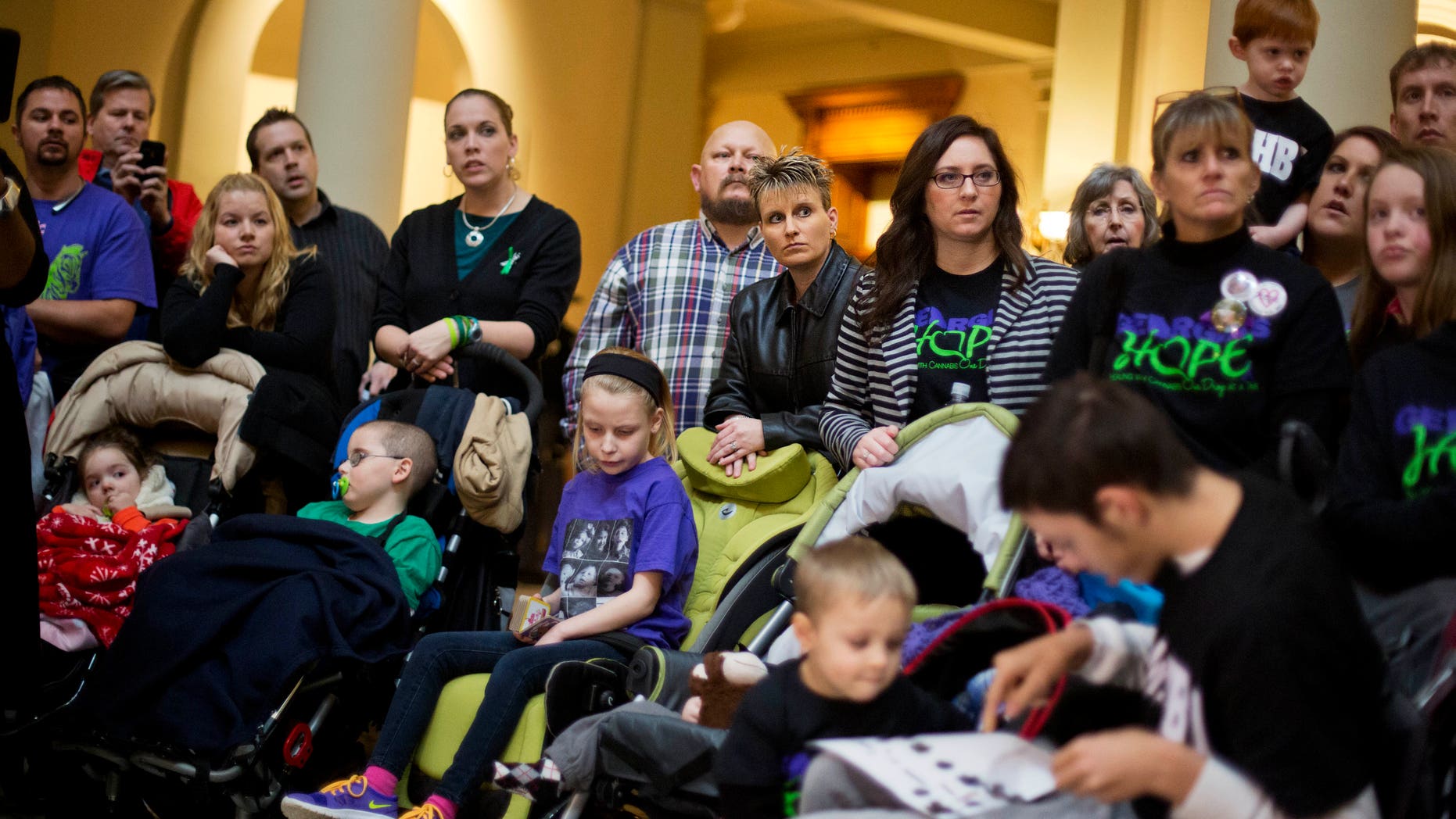 This Jan. 13, 2015 file photo, shows parents of children who suffer from epilepsy. (AP Photo/David Goldman, File)