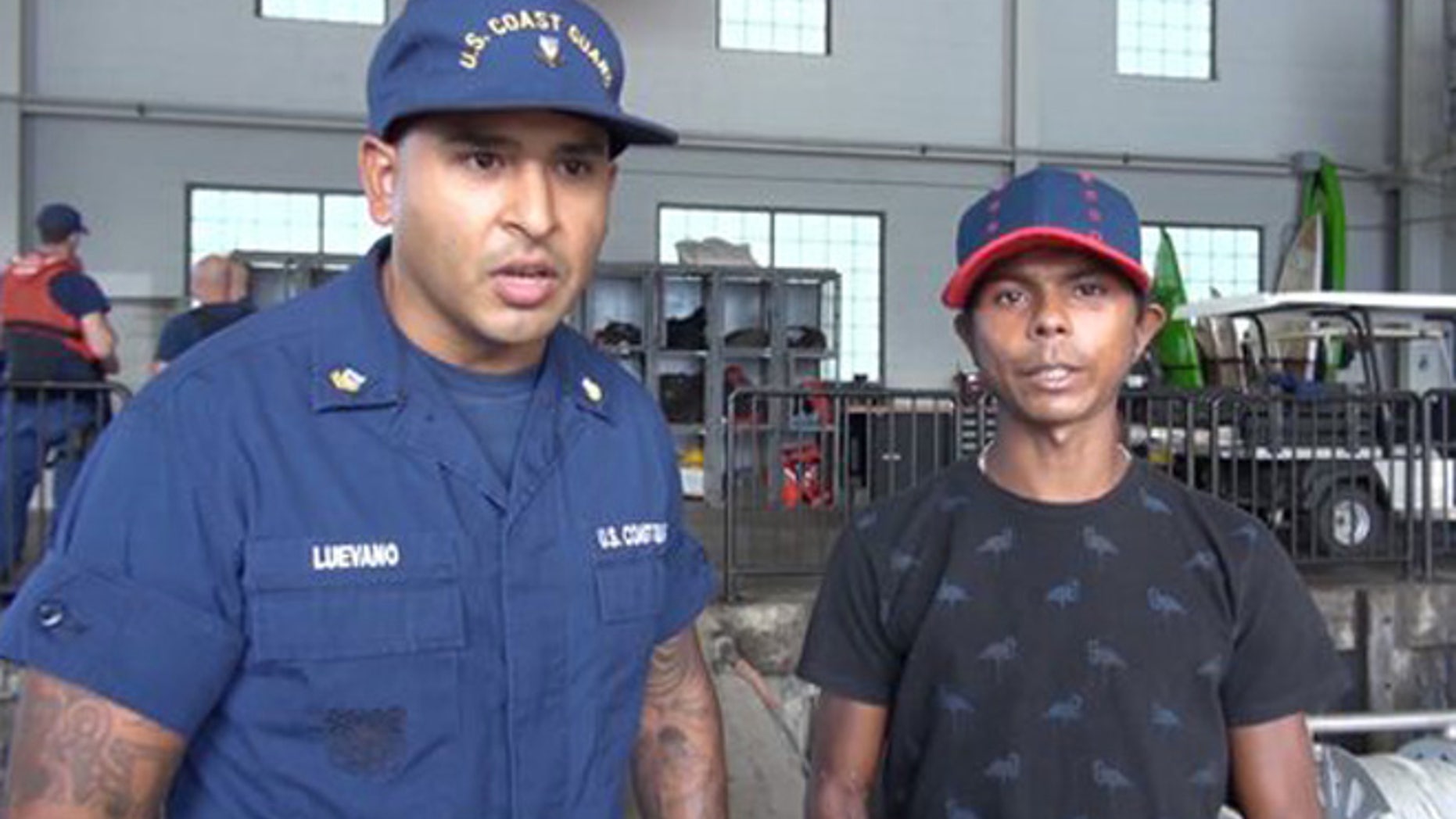 In this Wednesday, May 4, 2016 image taken from video, Petty Officer 2nd Class Simey Luevano, left, translates a statement from an unidentified mariner, right, after he was rescued at sea more than 2,000 miles southeast of Hawaii. The Colombian man survived a two-month ordeal in the Pacific by eating fish and seagulls, the U.S. Coast Guard said. (U.S. Coast Guard via AP)