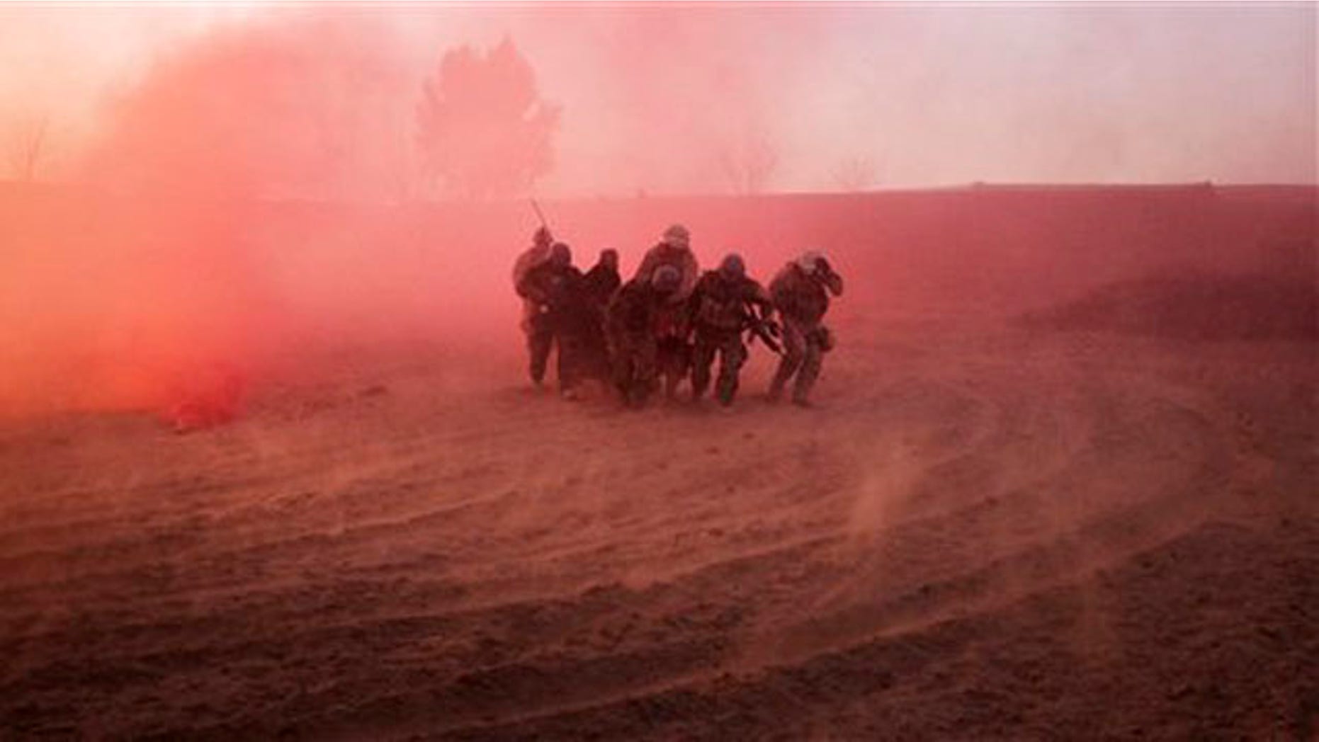 U.S. Marines and Afghan Army soldiers run with a wounded Afghan man to a waiting medevac helicopter near Marjah in southern Afghanistan Jan. 18.