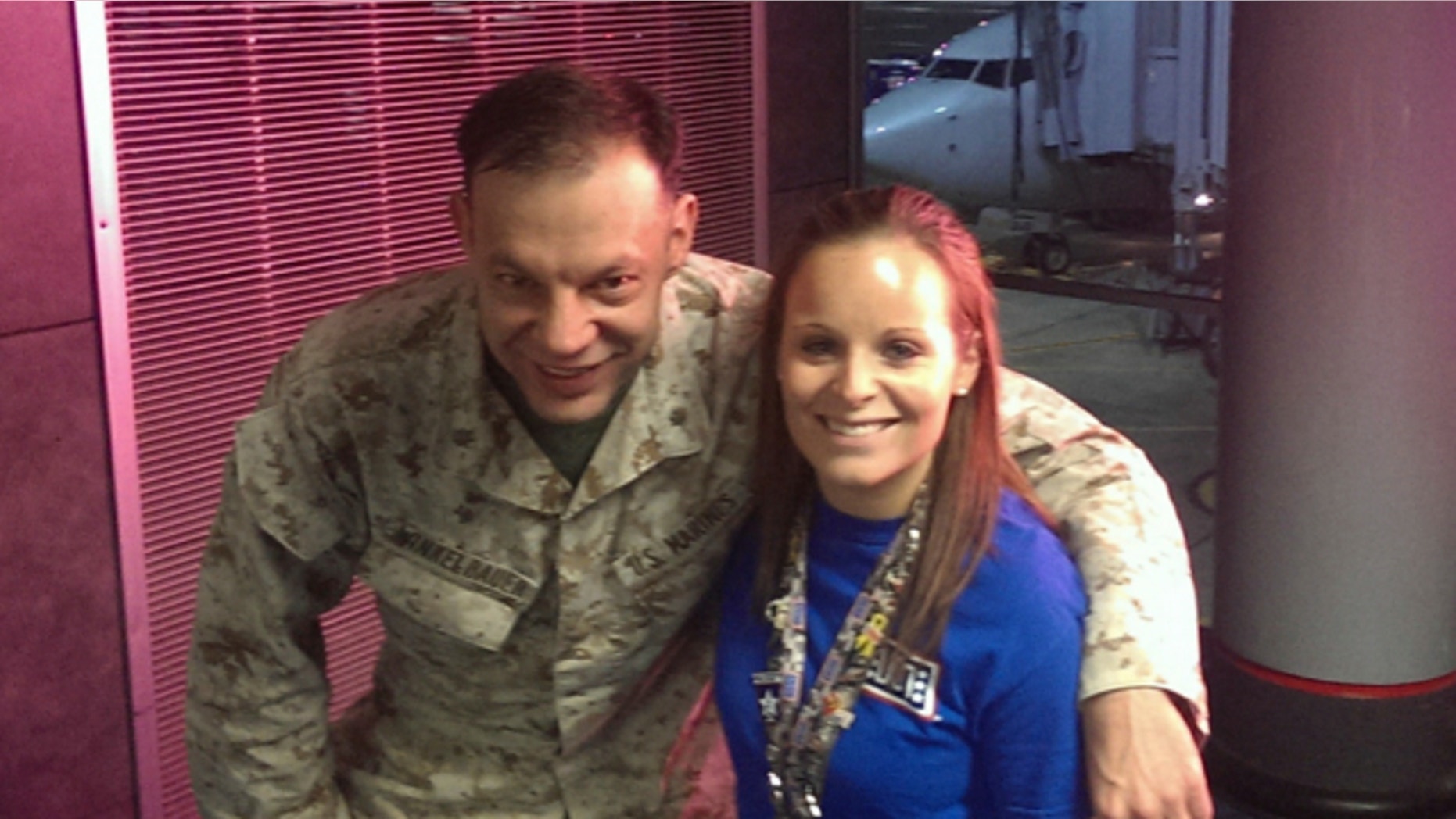 Nov. 4, 2013: Lindsy Wadas, director of the USO Center at Chicago's O'Hare International Airport, is shown with U.S. Marine Maj. Matthew Winkelbauer, left, after he and 13 other Marines arrived in Chicago before the final leg of their trip home to San Diego after a tour in Afghanistan.