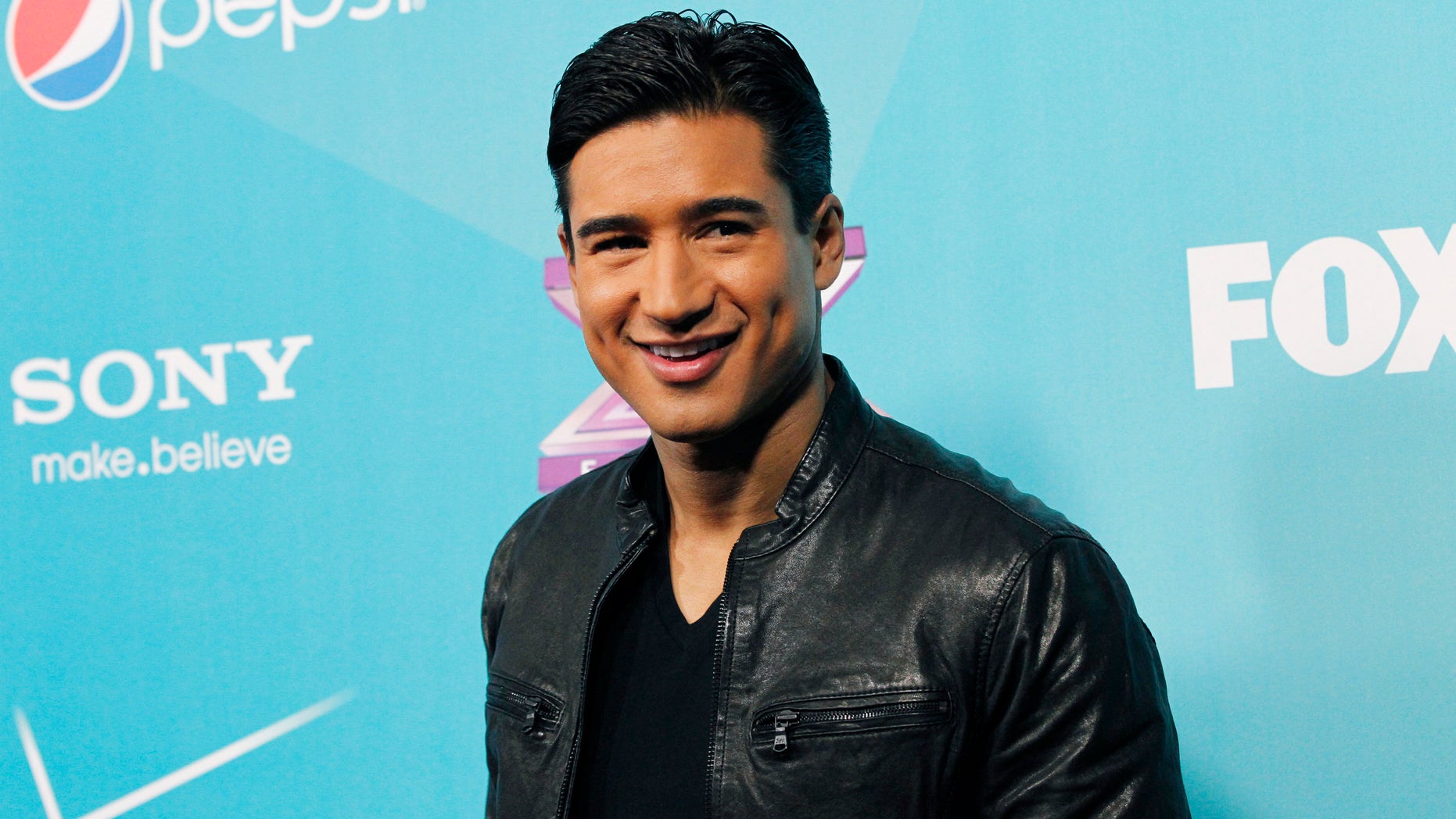 Host Mario Lopez poses at the party for the finalists of television series "The X Factor" in Los Angeles, California November 5, 2012. REUTERS/Mario Anzuoni (UNITED STATES - Tags: ENTERTAINMENT) - RTR3A1PH