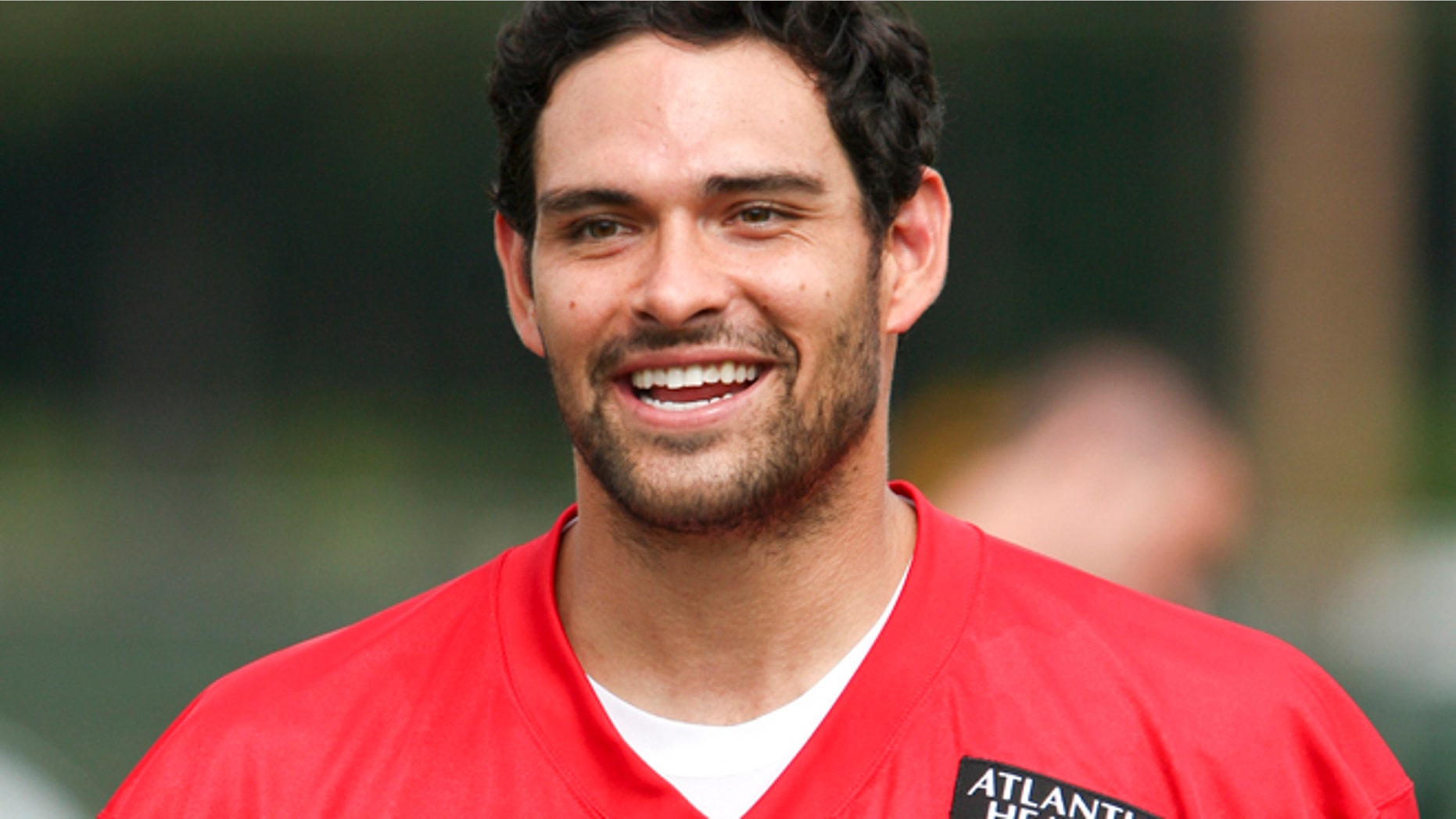 New York Jets quarterback Mark Sanchez smiles during Jets training camp practice in Cortland, New York, July 27, 2012.