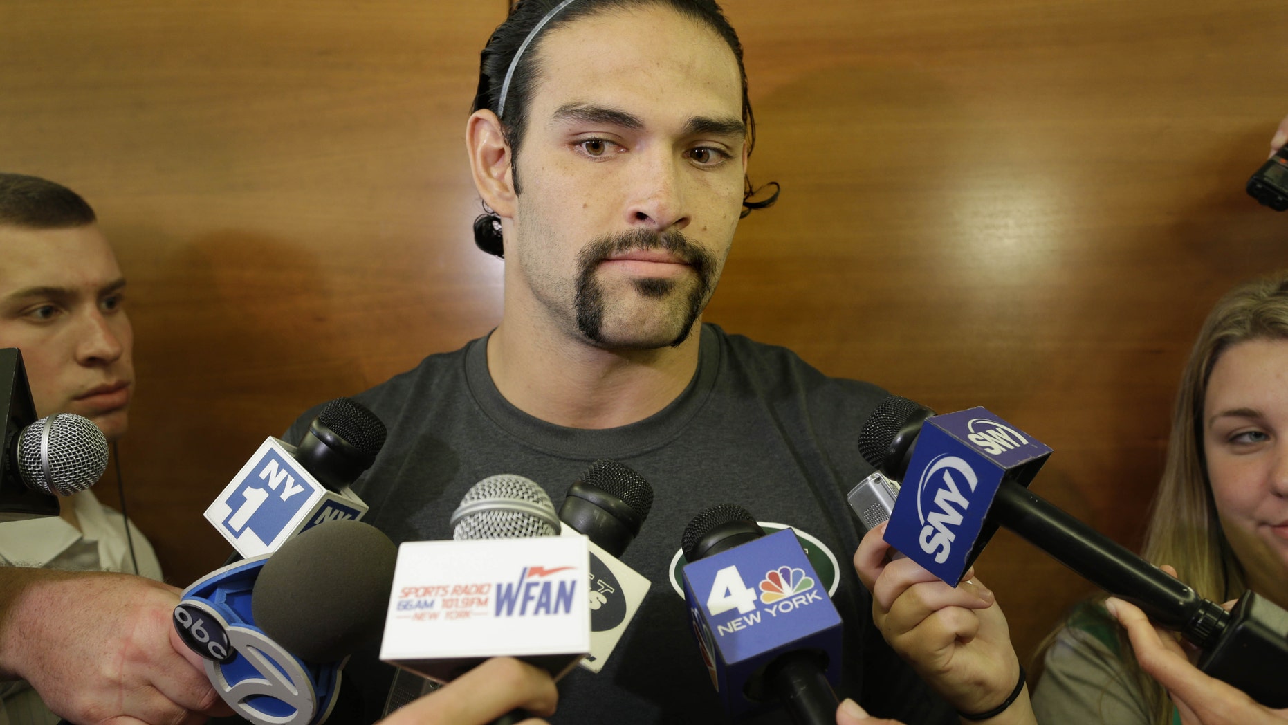 New York Jets quarterback Mark Sanchez talks to reporters after an NFL football practice in Florham Park, N.J., Monday, Aug. 19, 2013. (AP Photo/Seth Wenig)