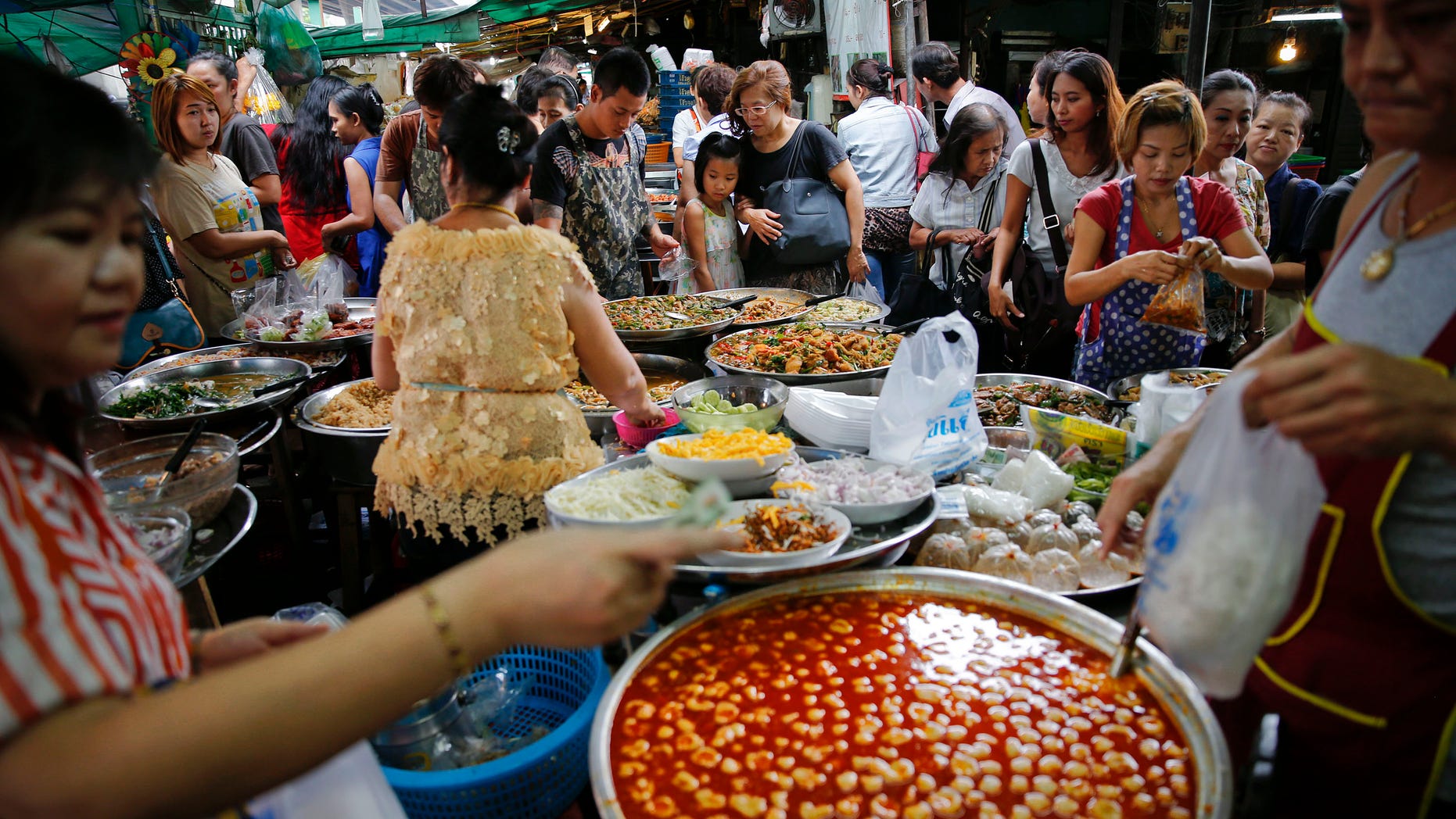 Aug. 1, 2014: People buy food at a market in central Bangkok.