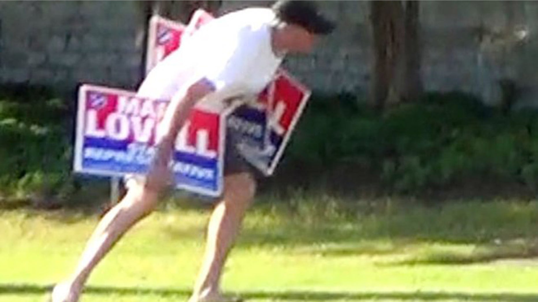This undated image taken from a cell phone video shows Tennessee State Rep. Curry Todd removing lawn signs supporting his opponent, Mark Lovell