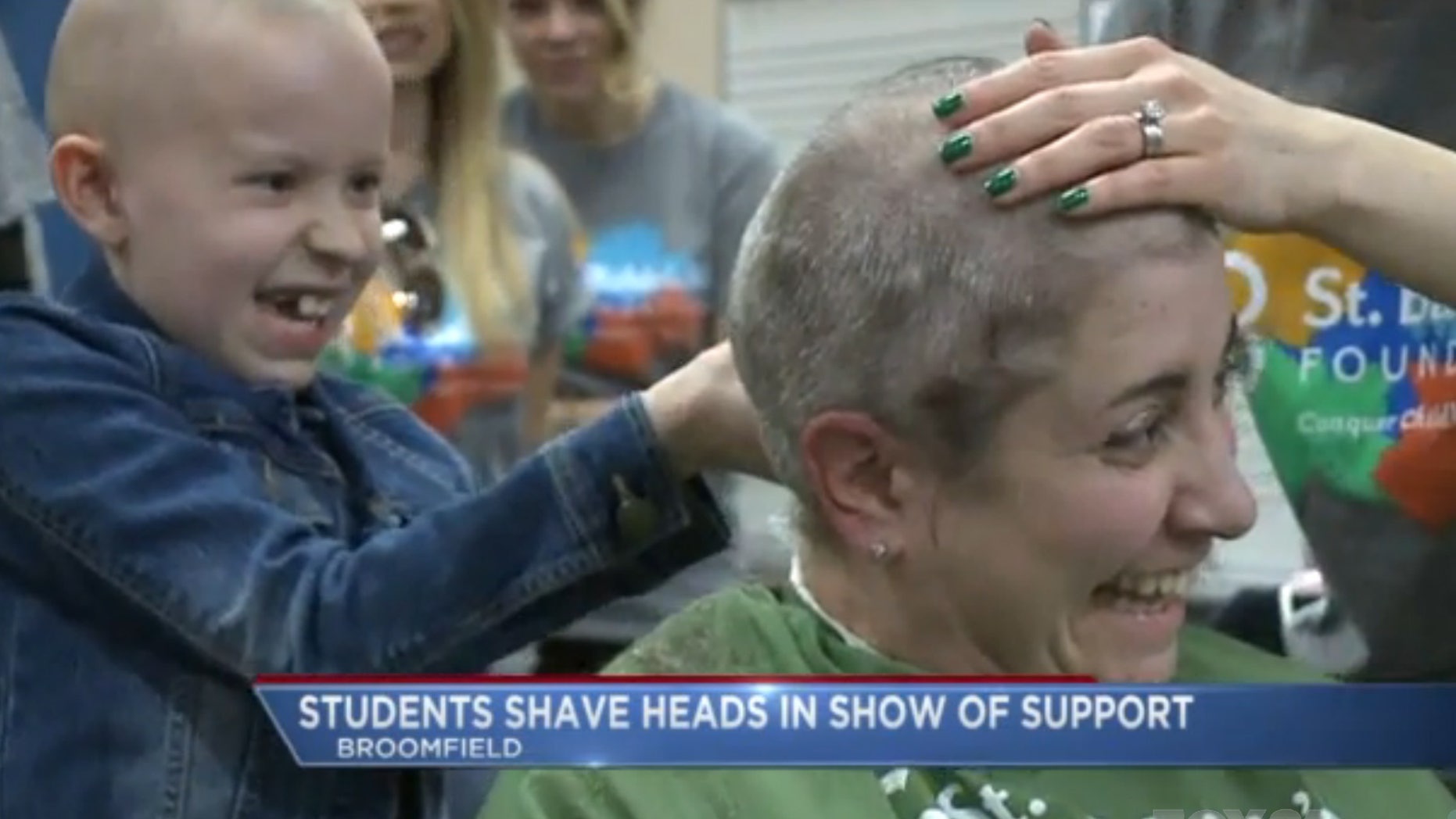 Marlee Pack shaves the head of a supporter. (Fox31)