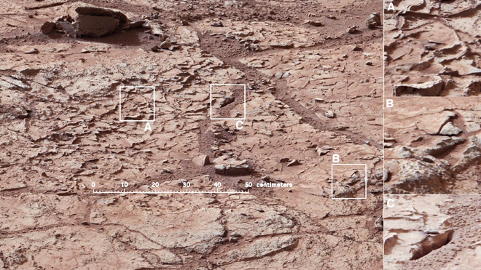 Jan. 10, 2013: The patch of veined, flat-lying rock selected as the first drilling site for NASA's Mars rover Curiosity. The area is shot full of fractures and veins, with the intervening rock also containing concretions, which are small spherical concentrations of minerals. At right, three boxes, each about 4 inches across, designate enlargements on the right that illustrate attributes of the area.