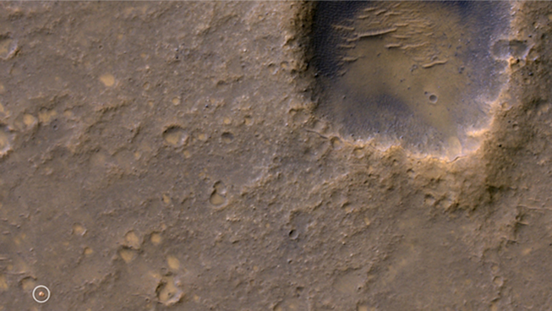 Caption:
Near the lower left corner of this view is the three-petal lander platform (circled) that NASA's Mars Exploration Rover Spirit drove off in January 2004.