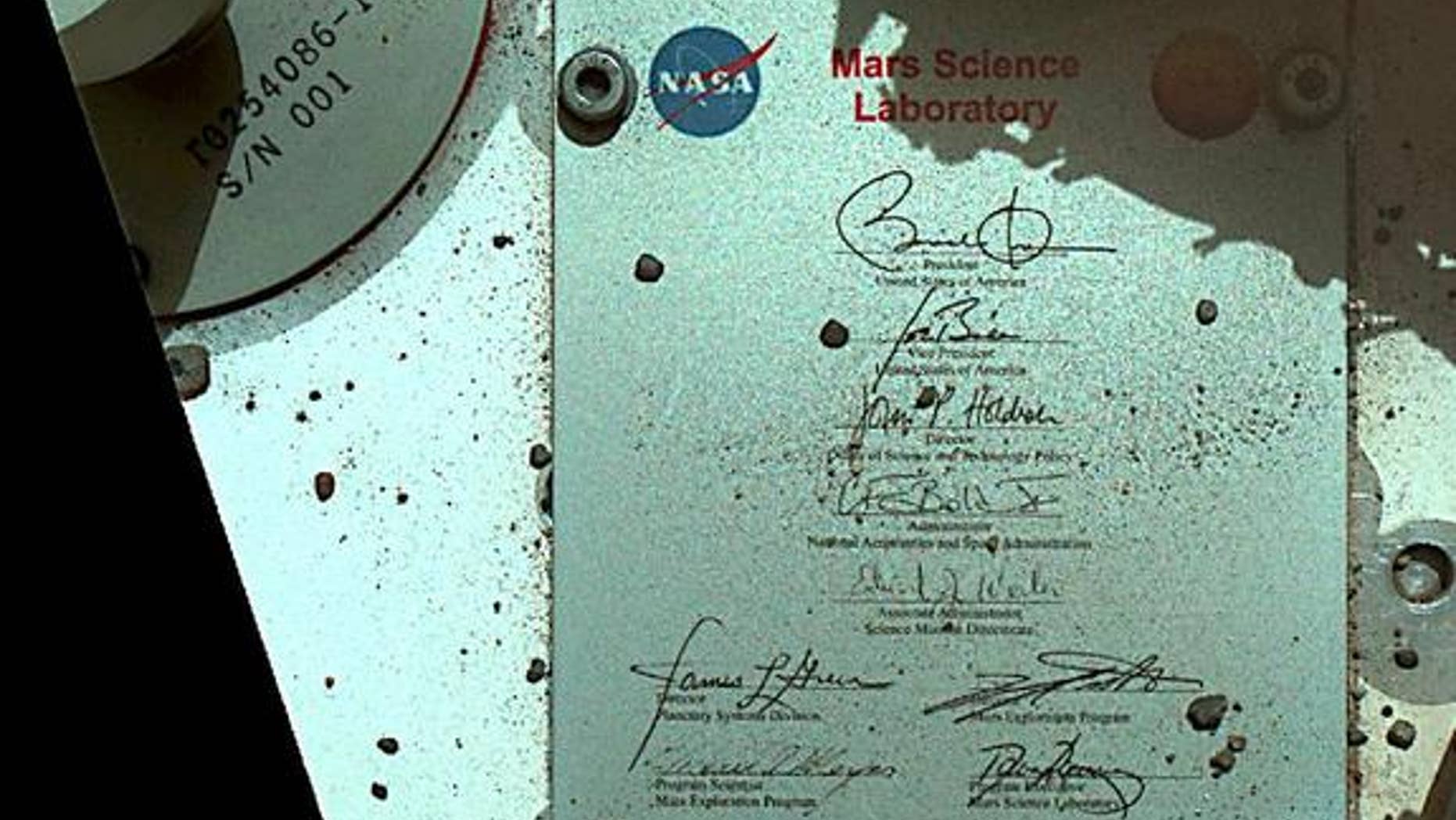 This view of Curiosity's deck shows a plaque bearing several signatures of US officials, including that of President Obama and Vice President Biden. The image was taken by the rover's Mars Hand Lens Imager (MAHLI) during the rover's 44th Martia